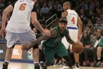 Feb 2, 2016; New York, NY, USA; Boston Celtics guard Isaiah Thomas (4) drives to the basket past New York Knicks forward Kristaps Porzingis (6) during the second half of an NBA basketball game at Madison Square Garden. The Celtics defeated the Knicks 97-8