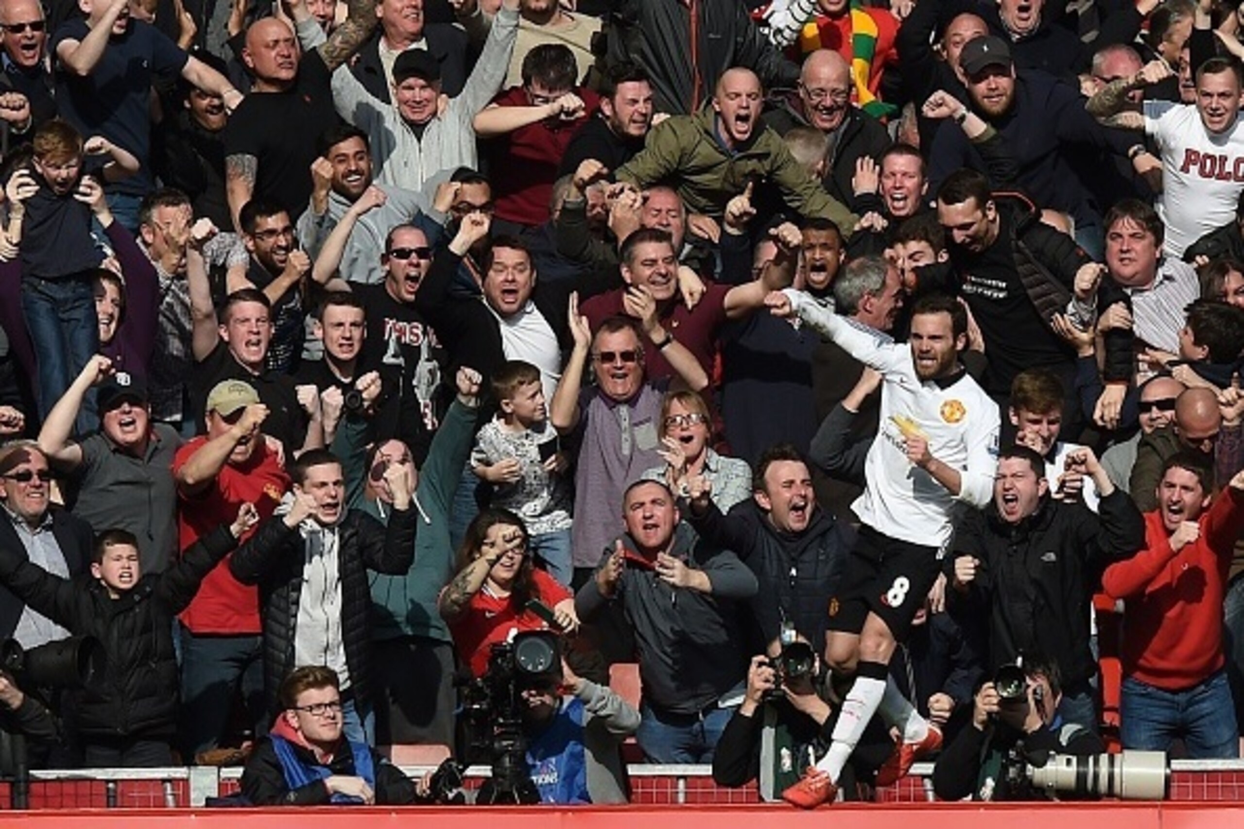 Manchester United's Spanish midfielder Juan Mata celebrates scoring his second goal in front of supporters during the English Premier League football match between Liverpool and Manchester United at Anfield in Liverpool, north west England on March 22, 20