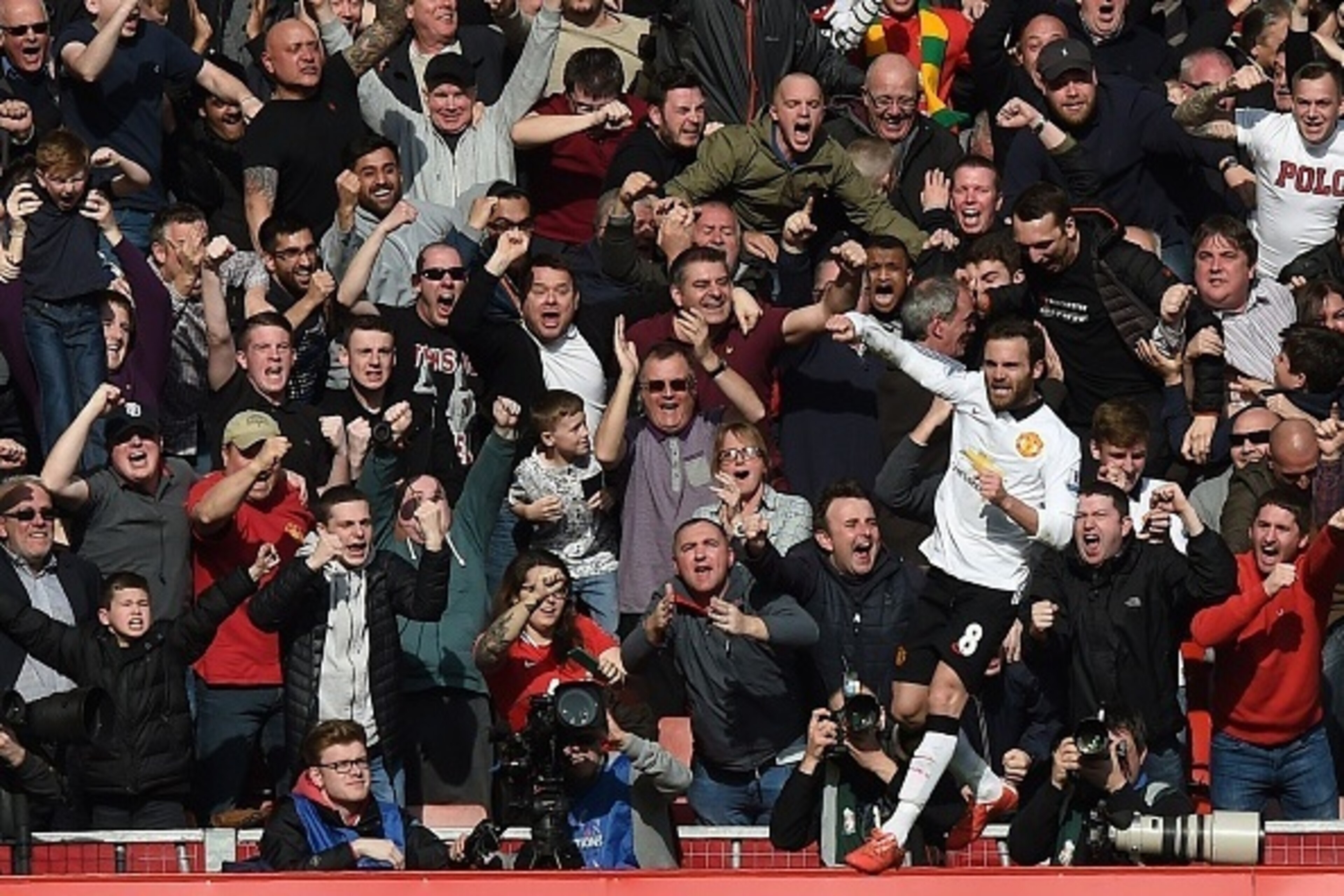 Manchester United's Spanish midfielder Juan Mata celebrates scoring his second goal in front of supporters during the English Premier League football match between Liverpool and Manchester United at Anfield in Liverpool, north west England on March 22, 20