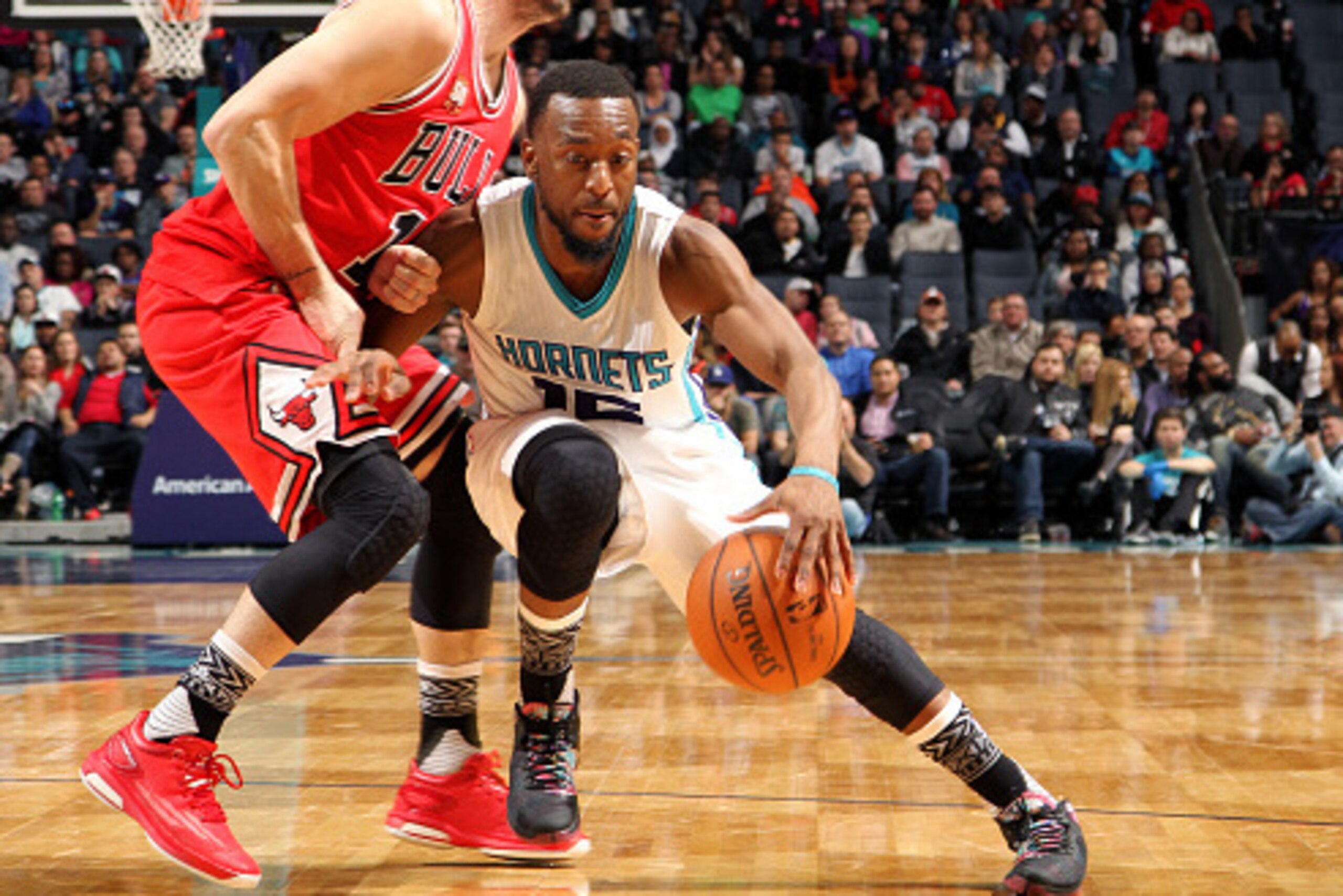 CHARLOTTE, NC - FEBRUARY 8: Kemba Walker #15 of the Charlotte Hornets handles the ball during the game against Kirk Hinrich #12 of the Chicago Bulls on February 8, 2016 at Time Warner Cable Arena in Charlotte, North Carolina. NOTE TO USER: User expressly 