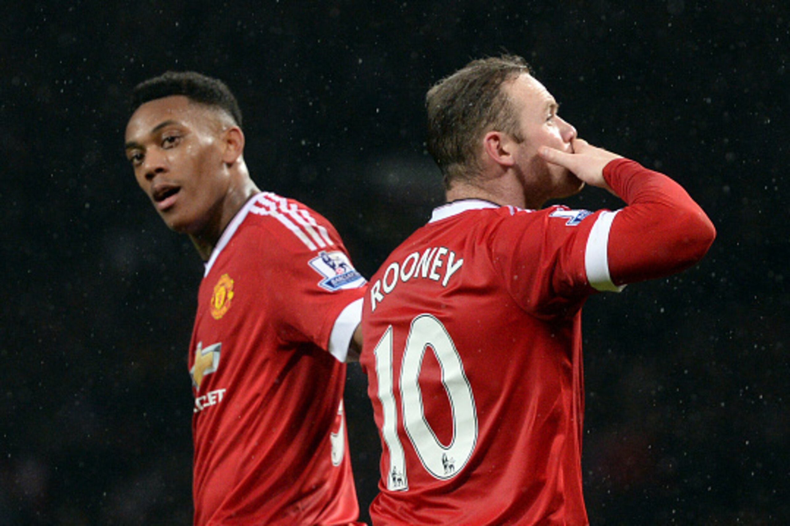 Manchester United's English striker Wayne Rooney celebrates scoring his team's second goal with Manchester United's French striker Anthony Martial during the English Premier League football match between Manchester United and Swansea City at Old Trafford 