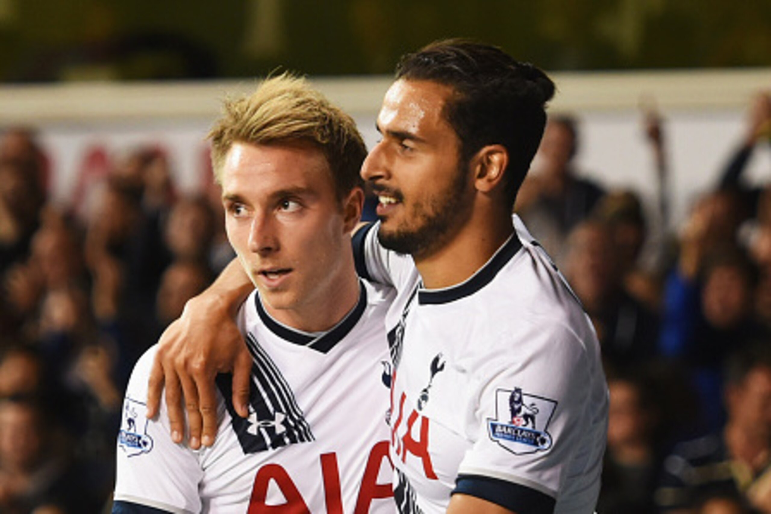LONDON, ENGLAND - SEPTEMBER 23:  Nacer Chadli of Tottenham Hotspur (R) celebrates with Christian Eriksen as Calum Chambers of Arsenal scores an own goal for their first goal during the Capital One Cup third round match between Tottenham Hotspur and Arsena