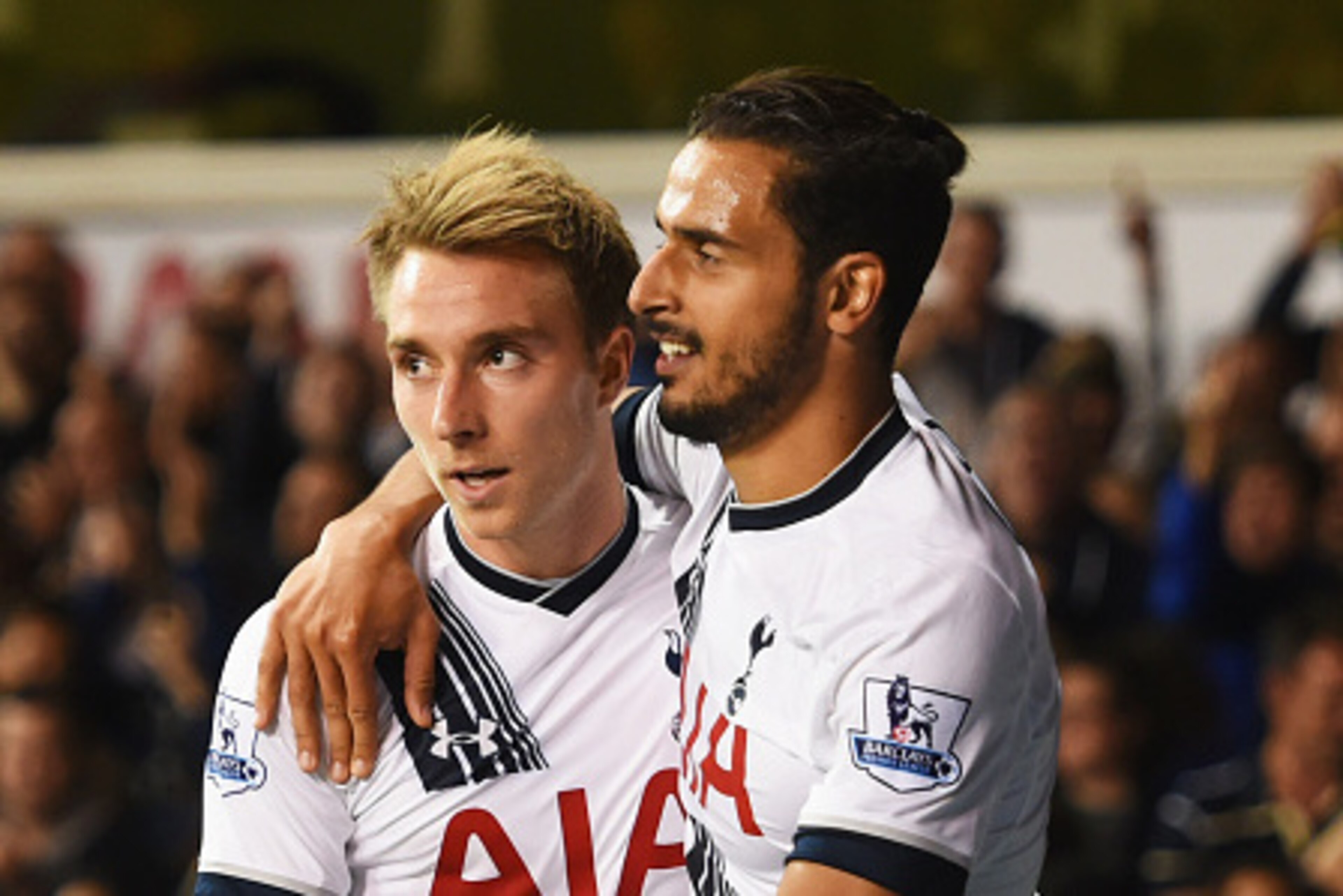 LONDON, ENGLAND - SEPTEMBER 23:  Nacer Chadli of Tottenham Hotspur (R) celebrates with Christian Eriksen as Calum Chambers of Arsenal scores an own goal for their first goal during the Capital One Cup third round match between Tottenham Hotspur and Arsena