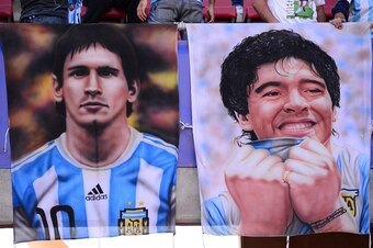 View of posters of Argentinian forward Lionel Messi and Argentinian football star Diego Maradona ahead of the Copa America 2015 football match between Argentina and Paraguay in La Serena, Chile on June 13, 2015. AFP PHOTO /  MARTIN BERNETTI        (Photo 