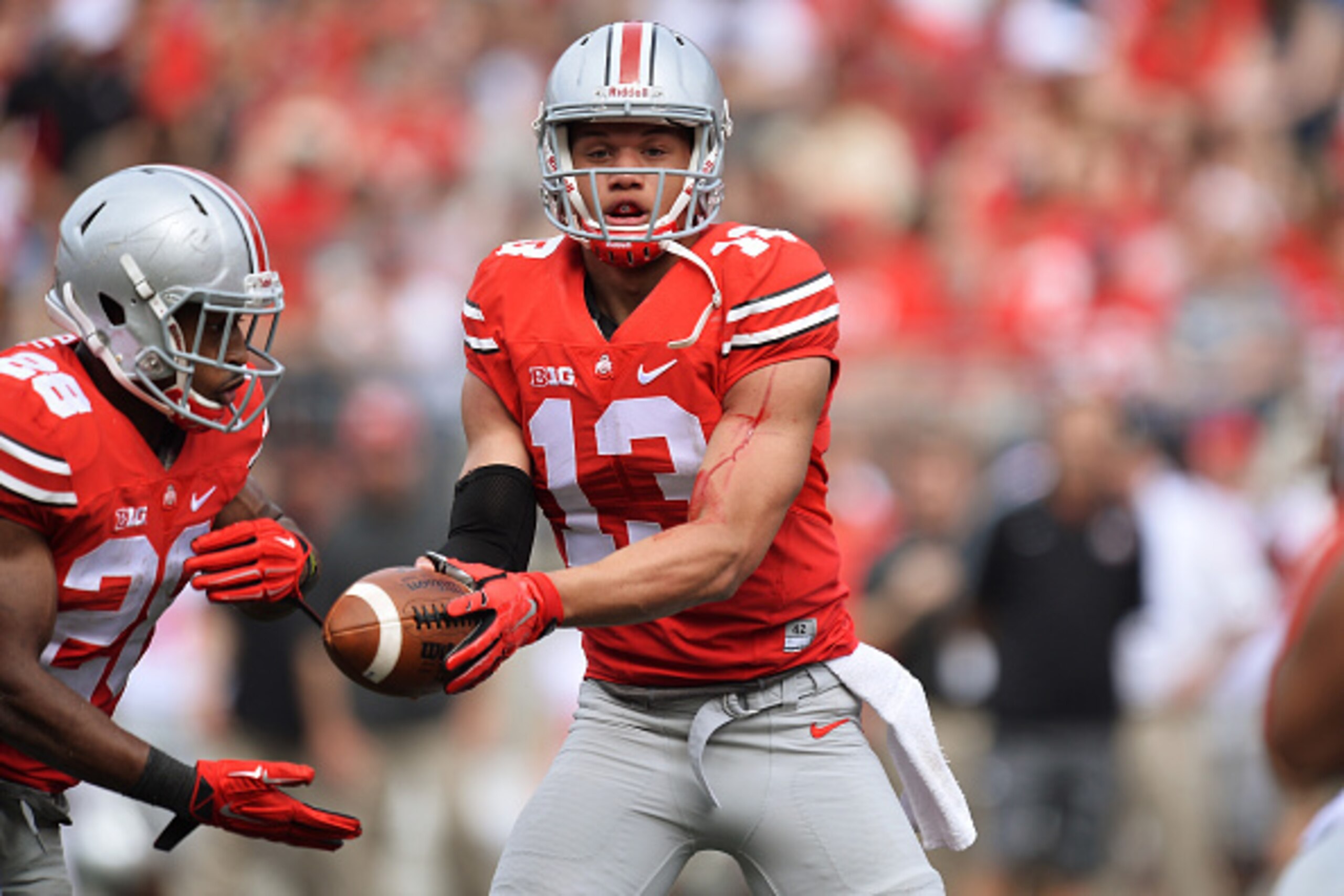 COLUMBUS, OH - APRIL 18: Quarterback Stephen Collier #13 of the Ohio State Buckeyes Scarlet team hands off to Warren Ball #28 of the Ohio State Buckeyes Scarlet team in the third quarter against the Gray team during the annual Ohio State Spring Game at O COLUMBUS, OH - APRIL 18: Quarterback Stephen Collier #13 of the Ohio State Buckeyes Scarlet team hands off to Warren Ball #28 of the Ohio State Buckeyes Scarlet team in the third quarter against the Gray team during the annual Ohio State Spring Game at O
