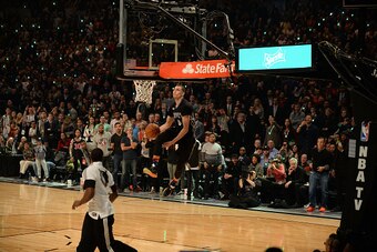 BROOKLYN, NY - FEBRUARY 14: Zach LaVine #8 of the Minnesota Timberwolves dunks with an assist from teammate Shabazz Muhammad #15 during the Sprite Slam Dunk Contest on State Farm All-Star Saturday Night as part of the 2015 NBA All-Star Weekend on February