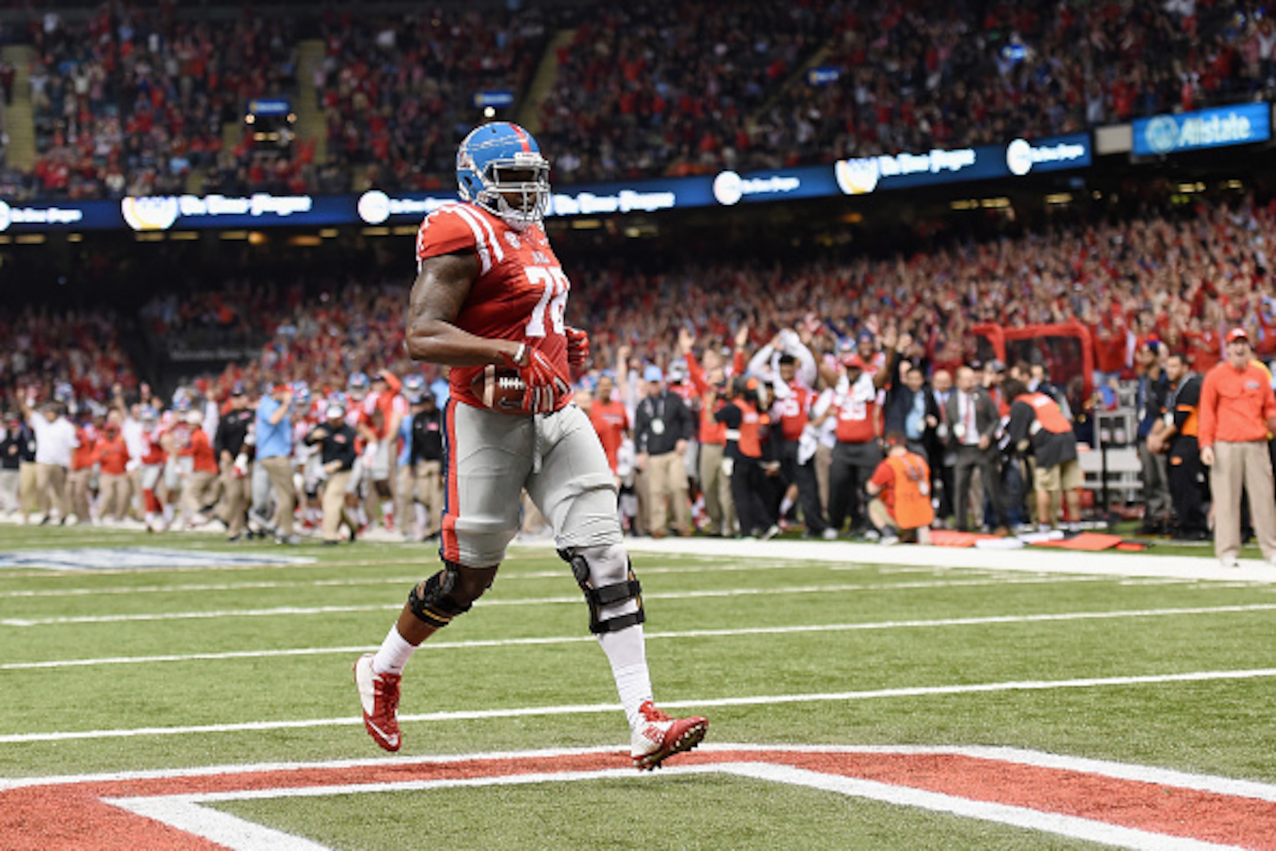 NEW ORLEANS, LA - JANUARY 01:  Laremy Tunsil #78 of the Mississippi Rebels scores runs in a touchdown during the second quarter against the Oklahoma State Cowboys in the Allstate Sugar Bowl at Mercedes-Benz Superdome on January 1, 2016 in New Orleans, Lou