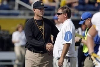Jan 1, 2016; Orlando, FL, USA; Michigan Wolverines head coach Jim Harbaugh (left) and Florida Gators head coach Jim McElwain meet at midfield before the 2016 Citrus Bowl at Orlando Citrus Bowl Stadium. Mandatory Credit: Reinhold Matay-USA TODAY Sports