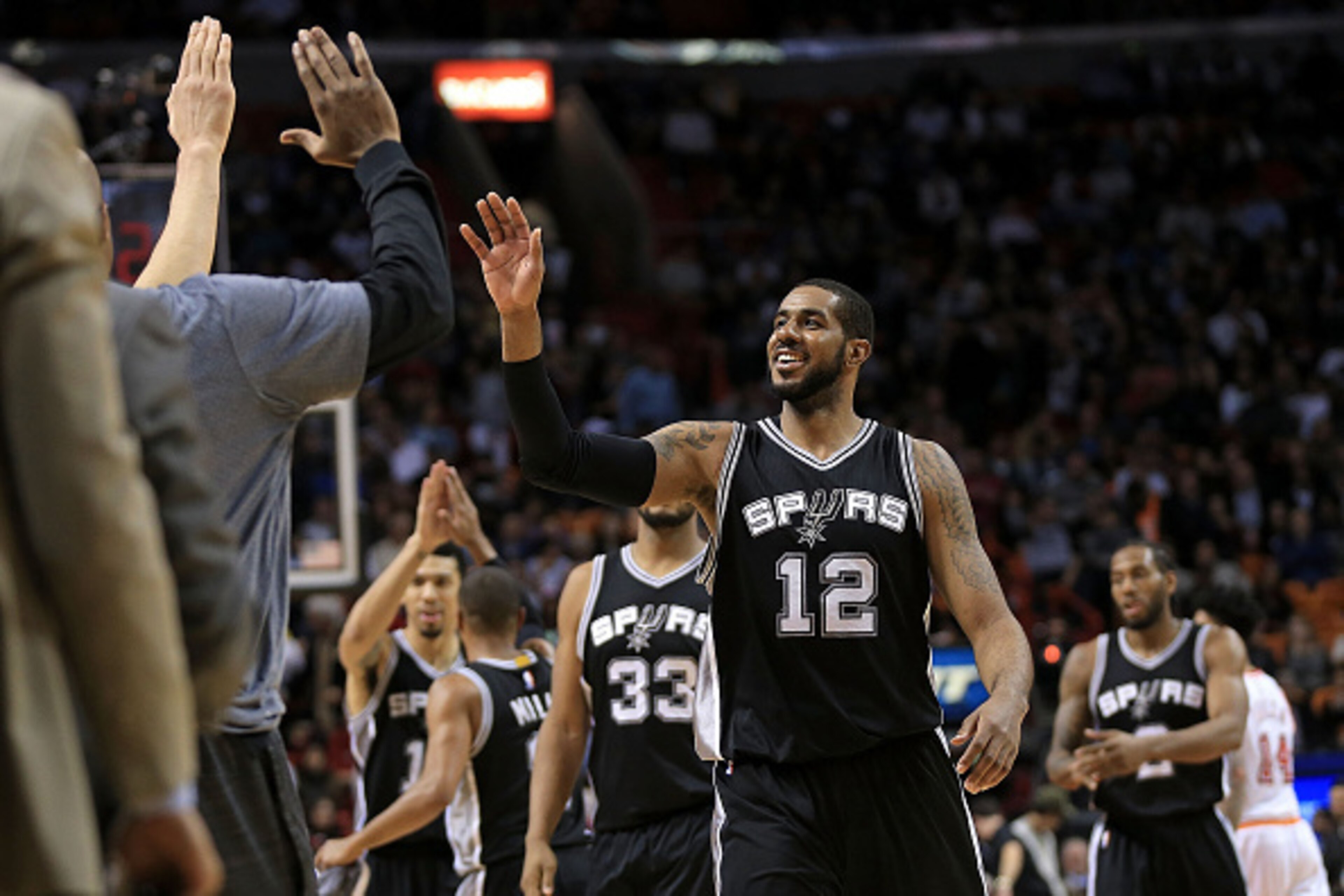 MIAMI, FL - FEBRUARY 09: LaMarcus Aldridge #12 of the San Antonio Spurs high fives during a game against the Miami Heat at American Airlines Arena on February 9, 2016 in Miami, Florida. NOTE TO USER: User expressly acknowledges and agrees that, by downloa