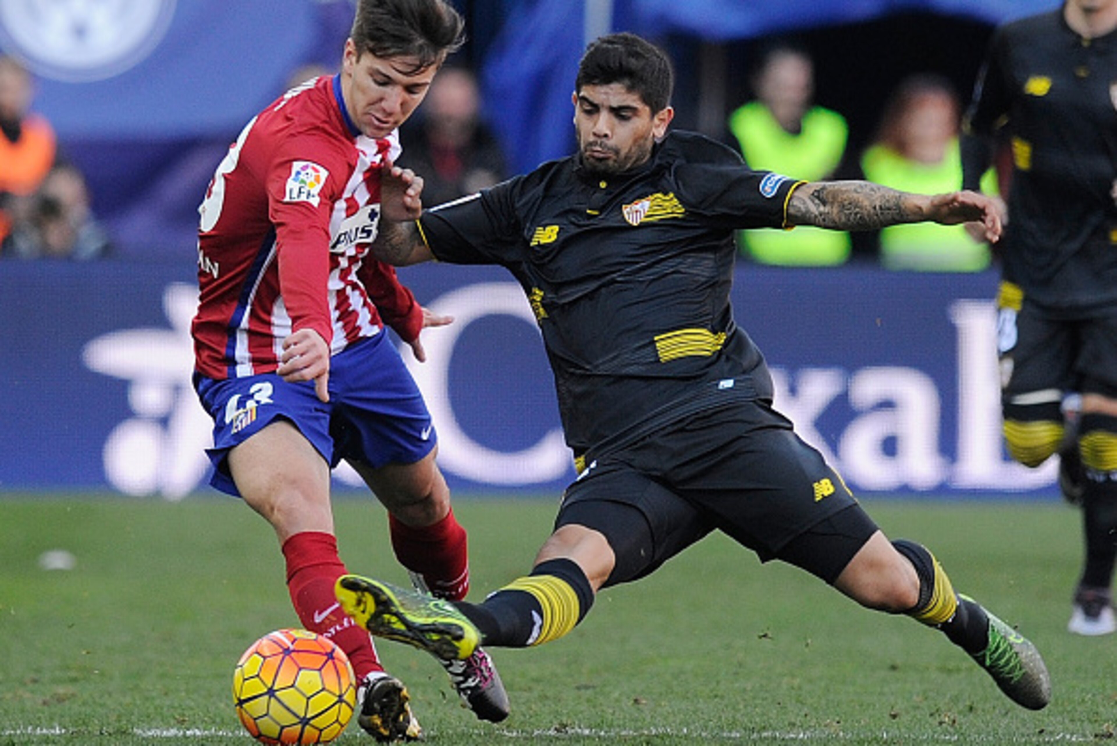 MADRID, SPAIN - JANUARY 24: Luciano Vietto of Club Atletico de Madrid is tackled by Ever Banega of Sevilla FC during the La Liga match between Club Atletico de Madrid and Sevilla FC at Vicente Calderon Stadium on January 24, 2016 in Madrid, Spain. (Pho MADRID, SPAIN - JANUARY 24: Luciano Vietto of Club Atletico de Madrid is tackled by Ever Banega of Sevilla FC during the La Liga match between Club Atletico de Madrid and Sevilla FC at Vicente Calderon Stadium on January 24, 2016 in Madrid, Spain. (Pho