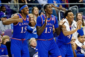 Feb 6, 2016; Fort Worth, TX, USA; Kansas Jayhawks forward Carlton Bragg Jr. (15) and forward Cheick Diallo (13) and guard Devonte' Graham (4) react during the first half against the TCU Horned Frogs at Ed and Rae Schollmaier Arena. Mandatory Credit: Kevin