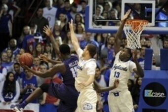 Jan 16, 2016; Lawrence, KS, USA; TCU Horned Frogs forward JD Miller (15) drives to the basket against Kansas Jayhawks guard Sviatoslav Mykhailiuk (10) and forward Cheick Diallo (13) in the second half at Allen Fieldhouse. Kansas won the game 70-63. Mandat