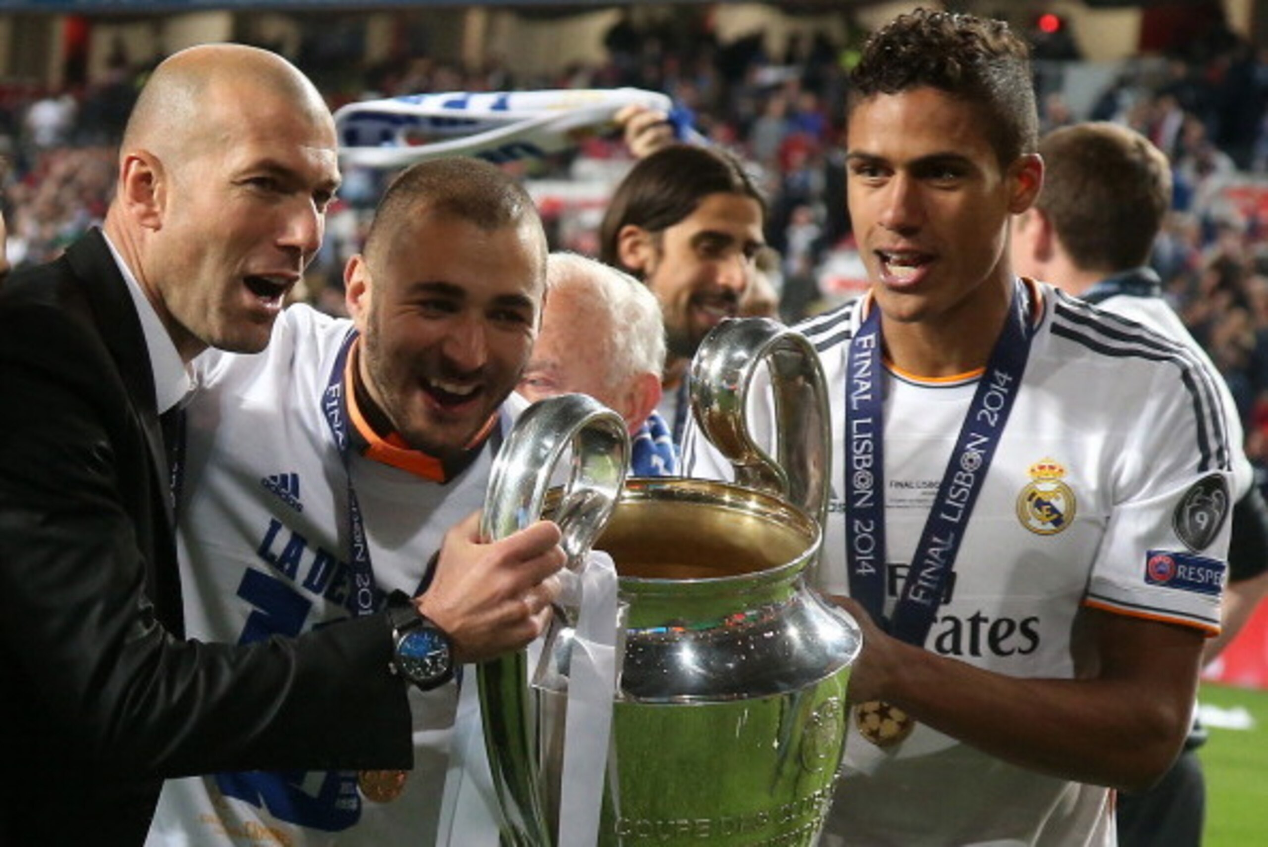 LISBON, PORTUGAL - MAY 24: Assistant-coach of Real Madrid Zinedine Zidane, Karim Benzema and Raphael Varane of Real Madrid hold the trophy after the UEFA Champions League final between Real Madrid and Atletico de Madrid at Estadio da Luz stadium on May 24 LISBON, PORTUGAL - MAY 24: Assistant-coach of Real Madrid Zinedine Zidane, Karim Benzema and Raphael Varane of Real Madrid hold the trophy after the UEFA Champions League final between Real Madrid and Atletico de Madrid at Estadio da Luz stadium on May 24