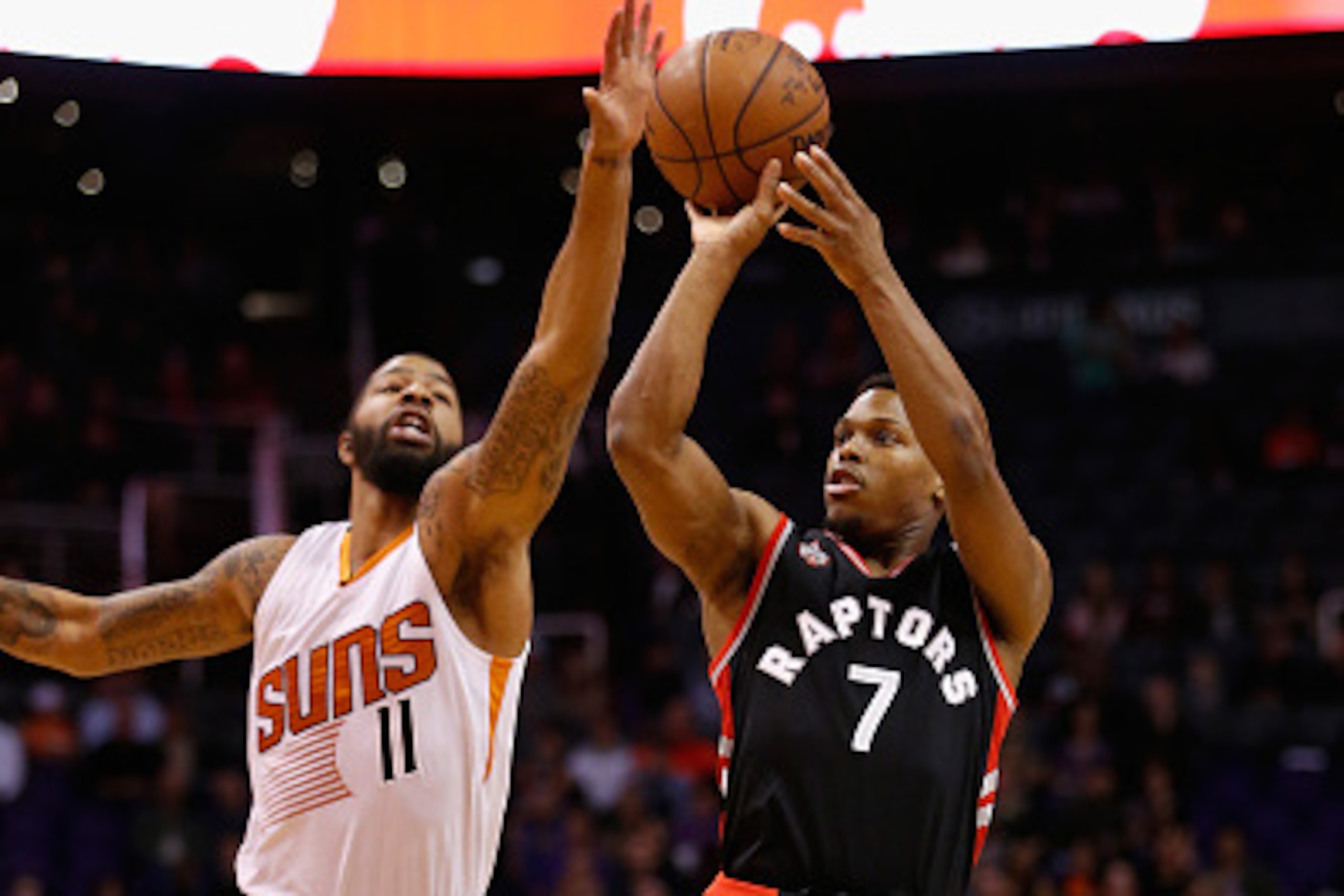 PHOENIX, AZ - FEBRUARY 02:  Kyle Lowry #7 of the Toronto Raptors attempts a shot over Markieff Morris #11 of the Phoenix Suns during the first half of the NBA game at Talking Stick Resort Arena on February 2, 2016 in Phoenix, Arizona.  NOTE TO USER: User 