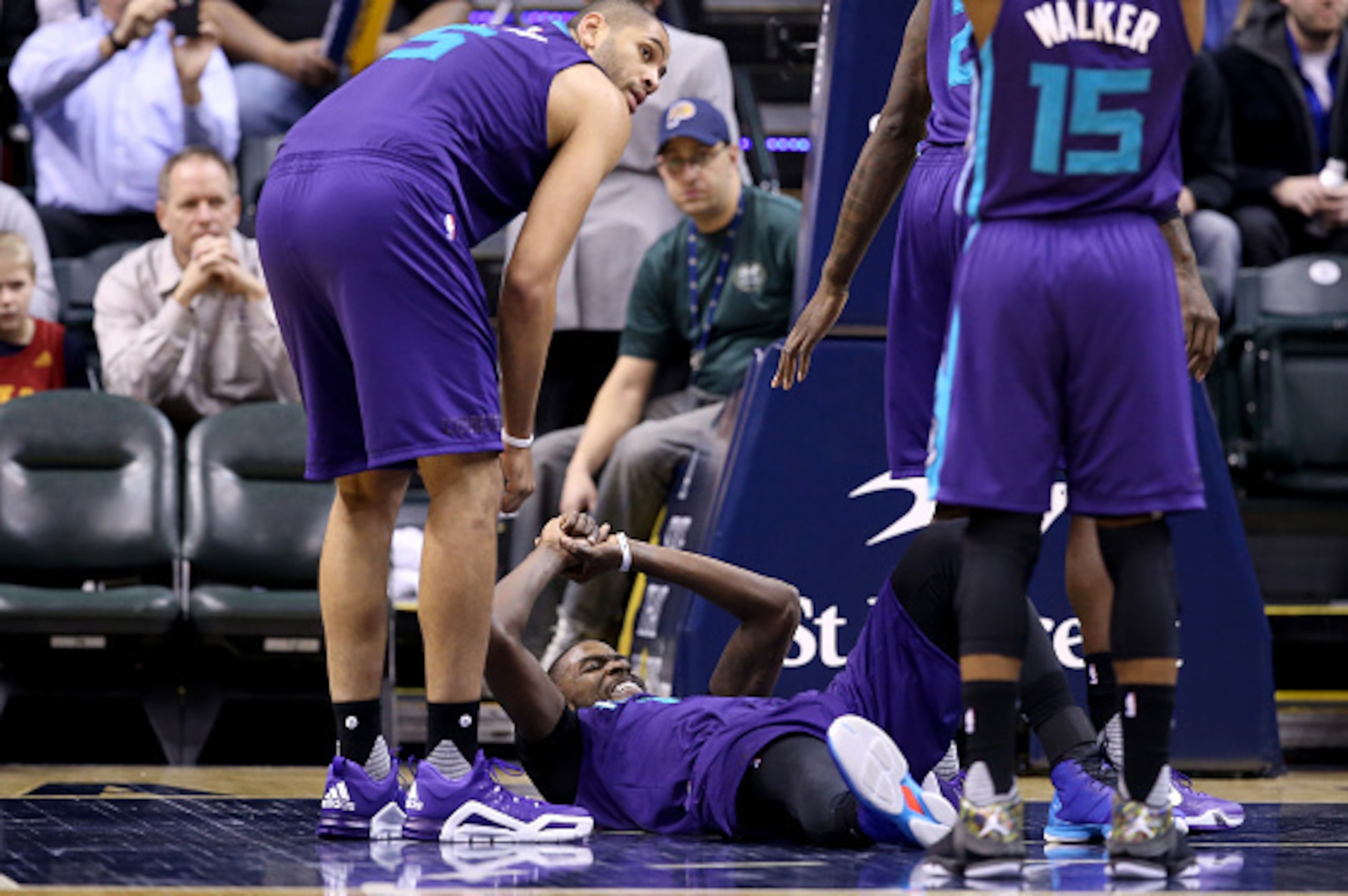 INDIANAPOLIS, IN - FEBRUARY 10: Michael Kidd-Gilchrist #14 of the Charlotte Hornets grimaces as he lies on the floor after being injured during the game against the Indiana Pacers at Bankers Life Fieldhouse on February 10, 2016 in Indianapolis, Indiana. INDIANAPOLIS, IN - FEBRUARY 10: Michael Kidd-Gilchrist #14 of the Charlotte Hornets grimaces as he lies on the floor after being injured during the game against the Indiana Pacers at Bankers Life Fieldhouse on February 10, 2016 in Indianapolis, Indiana.