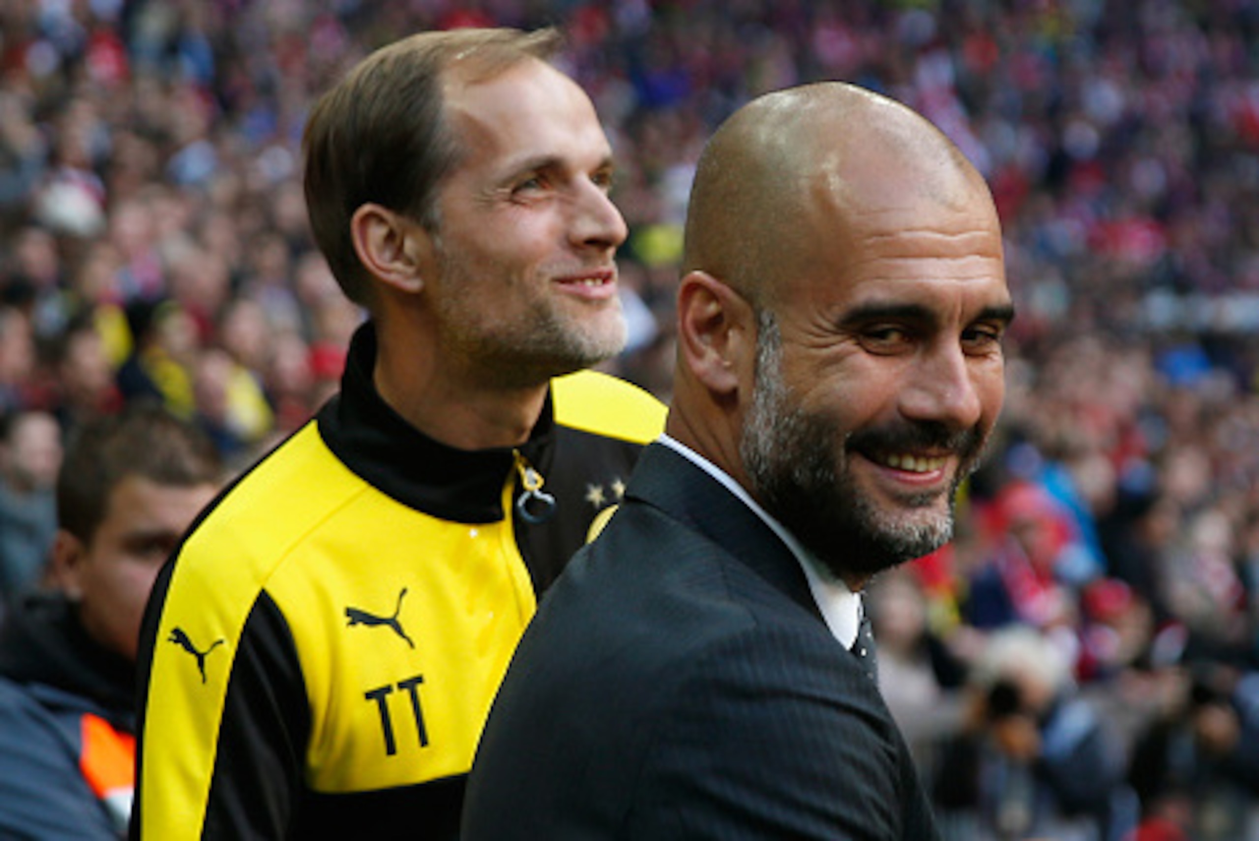 MUNICH, GERMANY - OCTOBER 04:  Thomas Tuchel, head coach of Borussia Dortmund shake hands with Pep Guardiola, head coach of Bayern Muenchen prior to the Bundesliga match between FC Bayern Muenchen and Borussia Dortmund at Allianz Arena on October 4, 2015 
