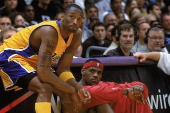 LOS ANGELES - JANUARY 12:  Kobe Bryant #8 of the Los Angeles Lakers and LeBron James #23 of the Cleveland Cavaliers sit on the sideline during the NBA game at Staples Center on January 12, 2003 in Los Angeles, California. The Lakers won 89-79.  NOTE TO US