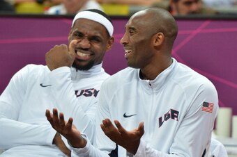 US forward LeBron James (L) chat with US guard Kobe Bryant (R) during the men's preliminary round basketball match USA vs Nigeria of the London 2012 Olympic Games  on August 2, 2012 at the basketball arena in London.     AFP PHOTO / MARK RALSTON        (P