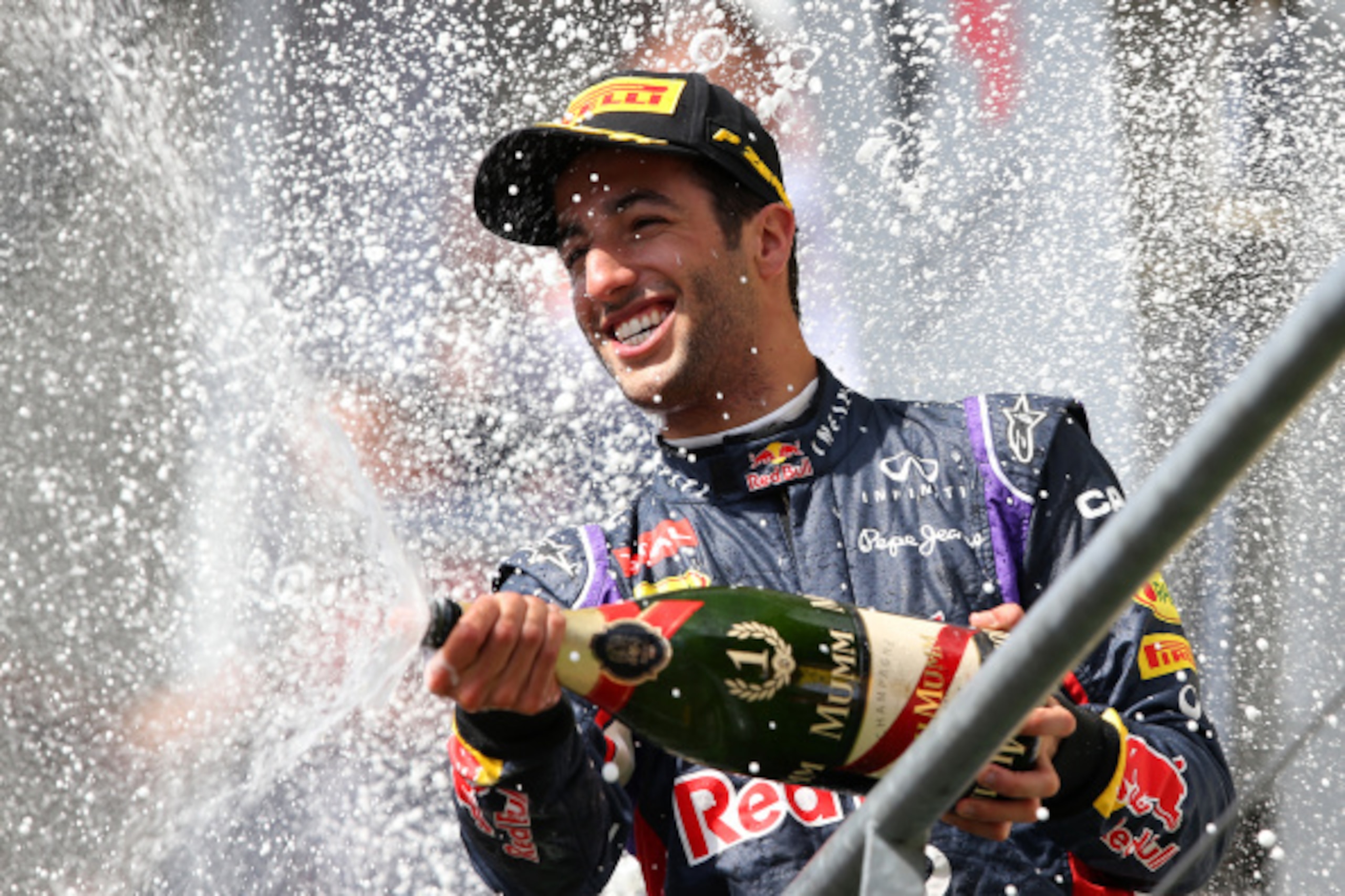 SPA, BELGIUM - AUGUST 24:  Daniel Ricciardo of Australia and Infiniti Red Bull Racing celebrates on the podium after winning the Belgian Grand Prix at Circuit de Spa-Francorchamps on August 24, 2014 in Spa, Belgium.  (Photo by Mark Thompson/Getty Images)