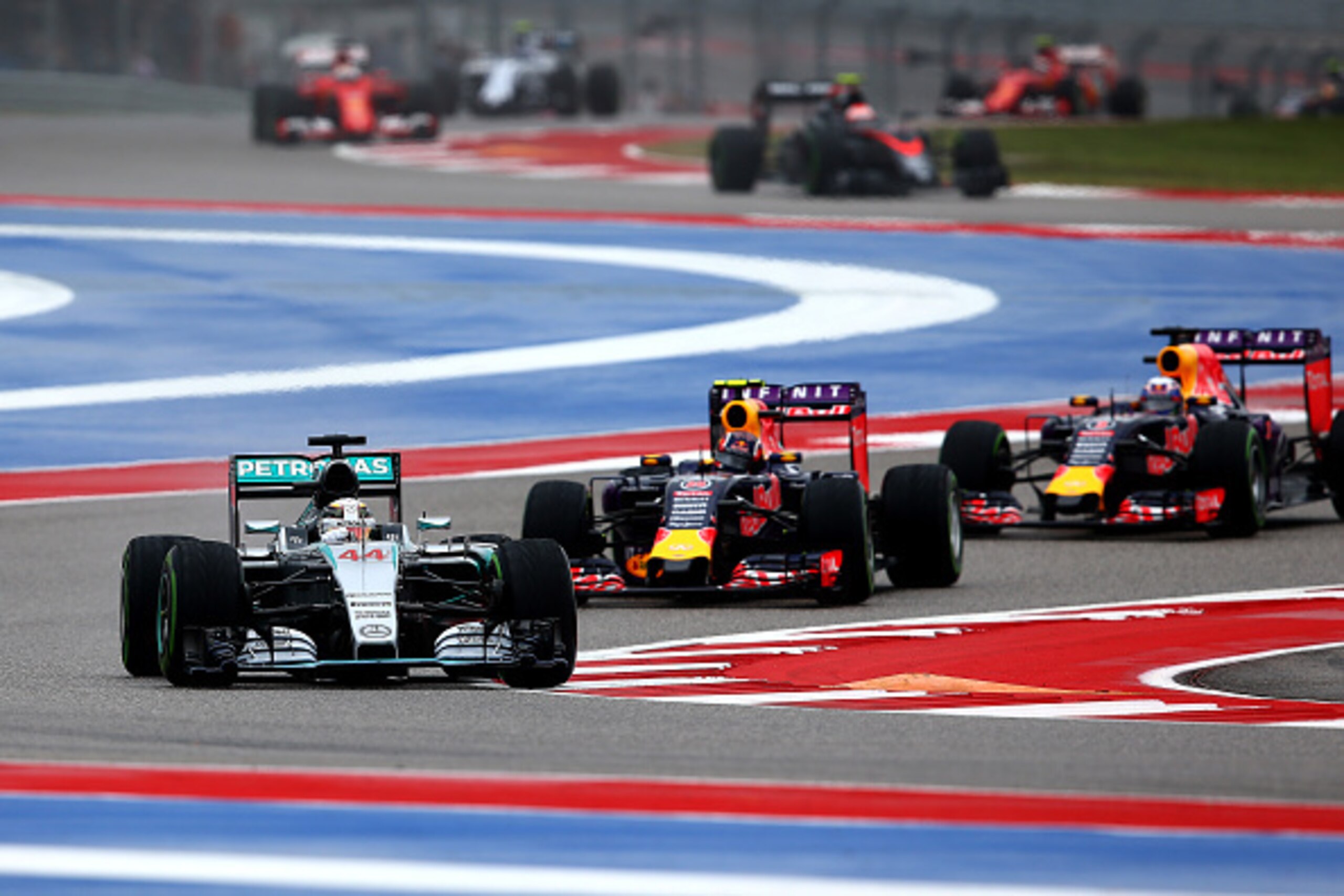 AUSTIN, TX - OCTOBER 25:  Lewis Hamilton of Great Britain and Mercedes GP leads Daniil Kvyat of Russia and Infiniti Red Bull Racing and Daniel Ricciardo of Australia and Infiniti Red Bull Racing during the United States Formula One Grand Prix at Circuit o