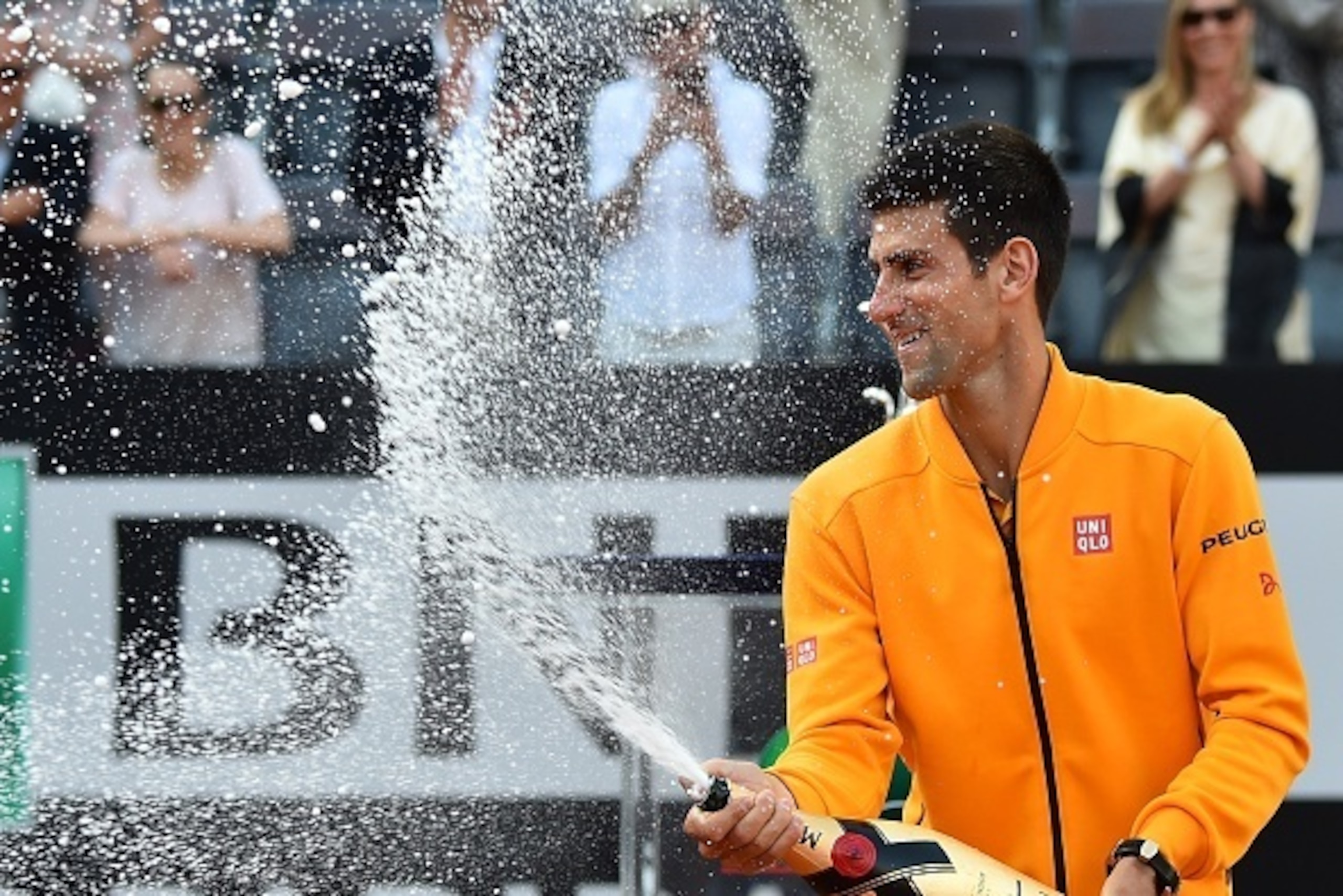 Novak Djokovic of Serbia sprays Champagne after winning the men's final match against Swiss Roger Federer at the ATP Tennis Open on May 17, 2015 at the Foro Italico in Rome. AFP PHOTO / GABRIEL BOUYS (Photo credit should read GABRIEL BOUYS/AFP/ Novak Djokovic of Serbia sprays Champagne after winning the men's final match against Swiss Roger Federer at the ATP Tennis Open on May 17, 2015 at the Foro Italico in Rome. AFP PHOTO / GABRIEL BOUYS (Photo credit should read GABRIEL BOUYS/AFP/