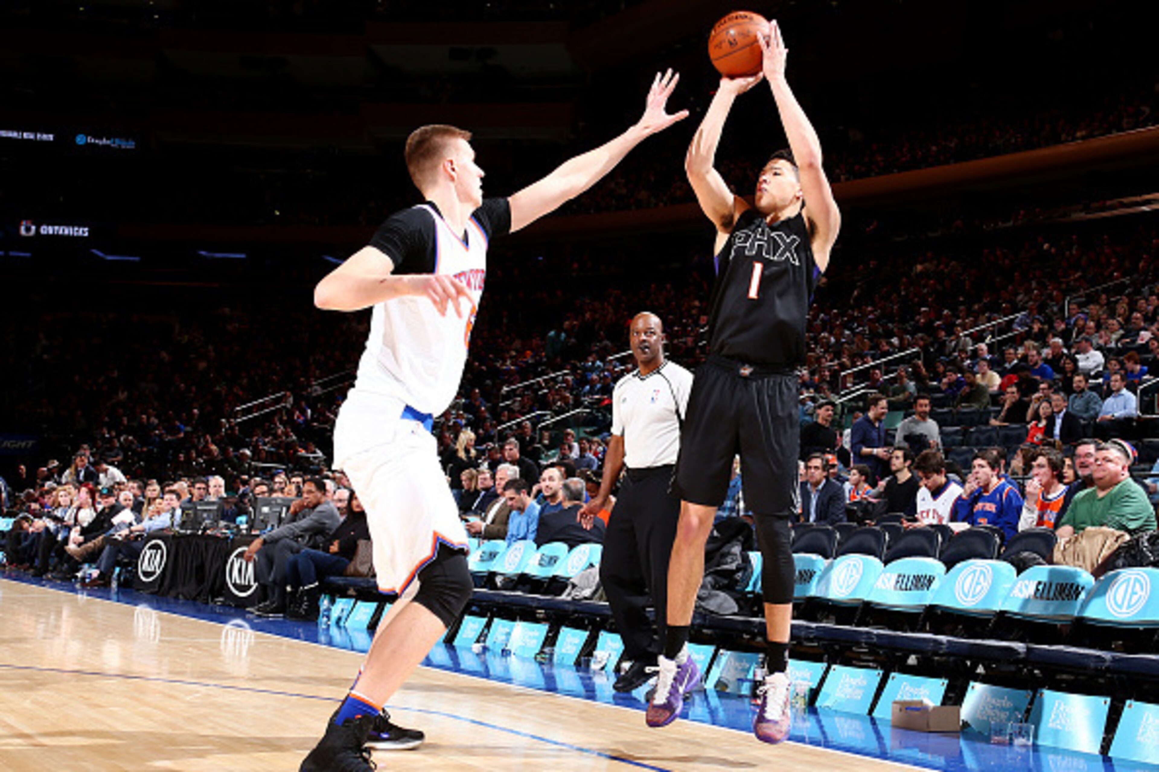 NEW YORK, NY - JANUARY 29:  Devin Booker #1 of the Phoenix Suns shoots the ball against Kristaps Porzingis #6 of the New York Knicks on January 29, 2016 at Madison Square Garden in New York City, New York.  NOTE TO USER: User expressly acknowledges and ag