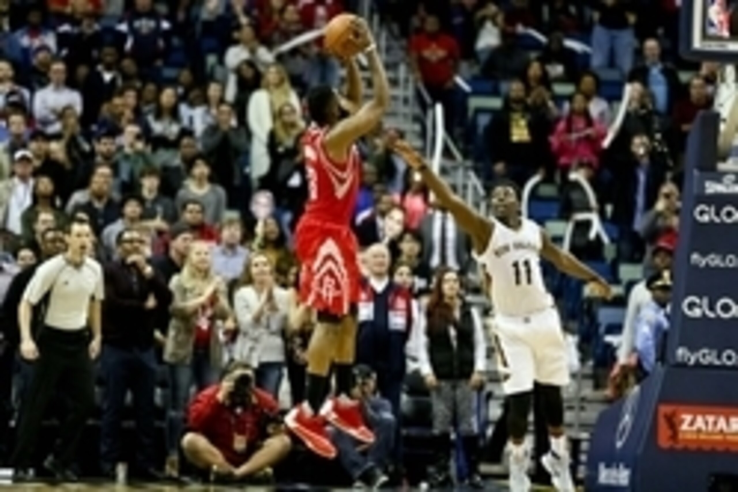 Jan 25, 2016; New Orleans, LA, USA; Houston Rockets guard James Harden (13) shoots over New Orleans Pelicans guard Jrue Holiday (11) during the fourth quarter of a game at the Smoothie King Center. The Rockets defeated the Pelicans 112-111. Mandatory Cred