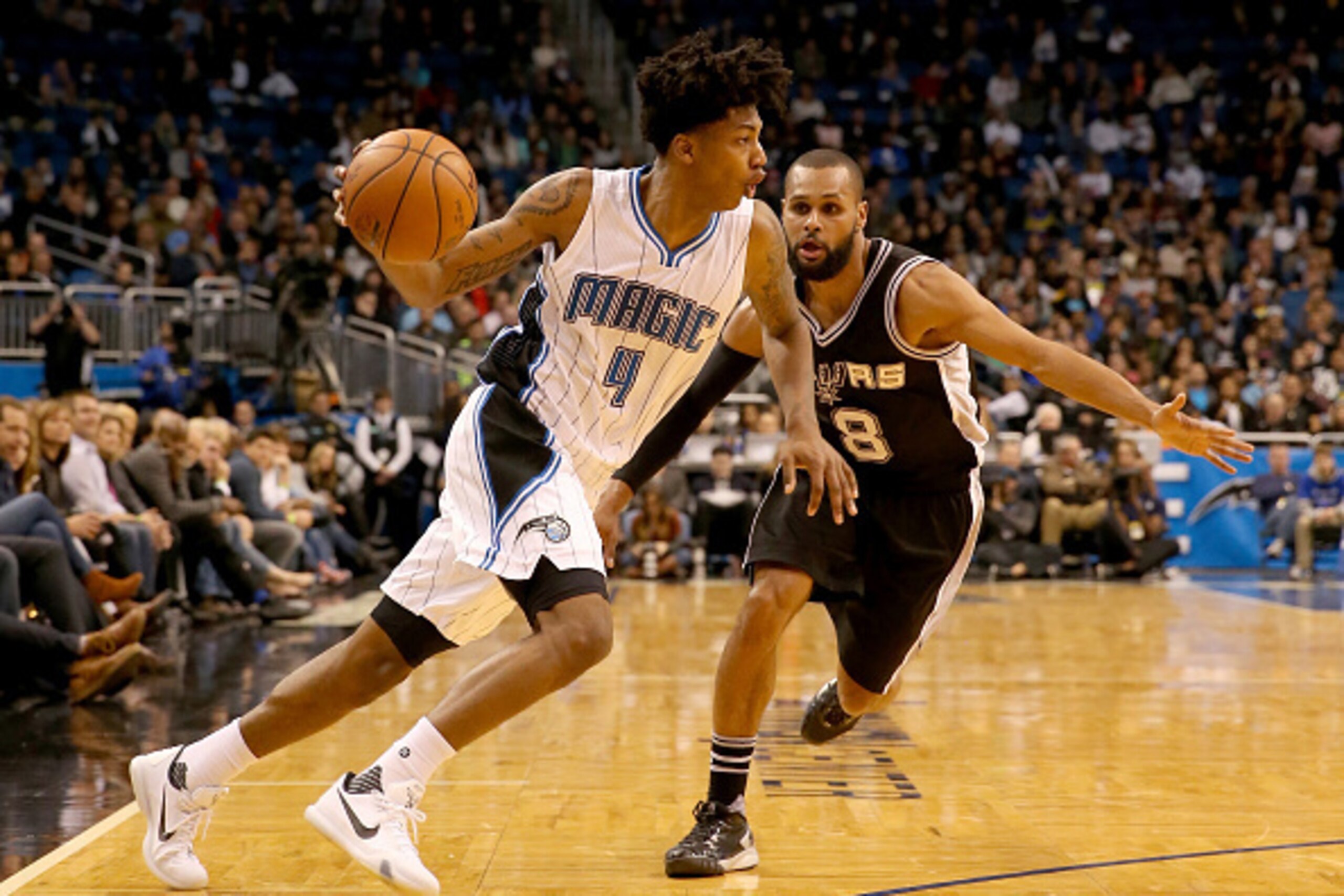 ORLANDO, FL - FEBRUARY 10:  Elfrid Payton #4 of the Orlando Magic drives past Patty Mills #8 of the San Antonio Spurs during the game at Amway Center on February 10, 2016 in Orlando, Florida. NOTE TO USER: User expressly acknowledges and agrees that, by d