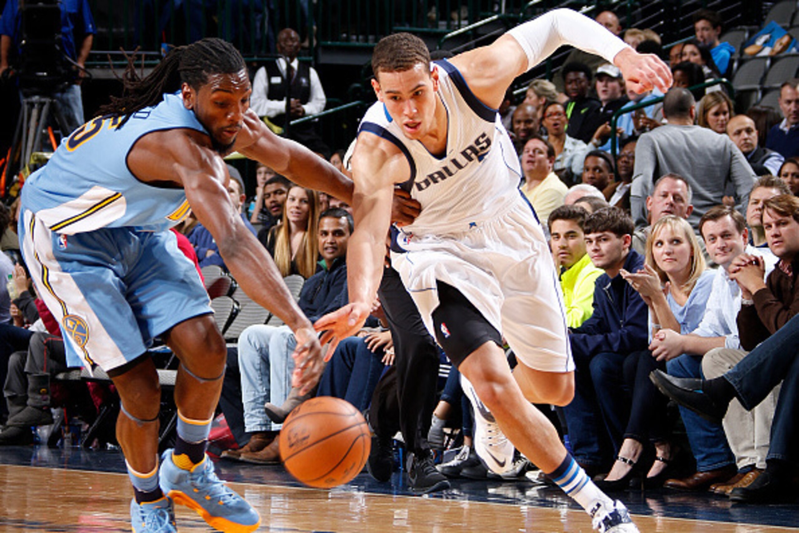 DALLAS, TX - NOVEMBER 28: Dwight Powell #7 of the Dallas Mavericks tries to keep the ball away from Kenneth Faried #35 of the Denver Nuggets on November 28, 2015 at the American Airlines Center in Dallas, Texas. NOTE TO USER: User expressly acknowledges a