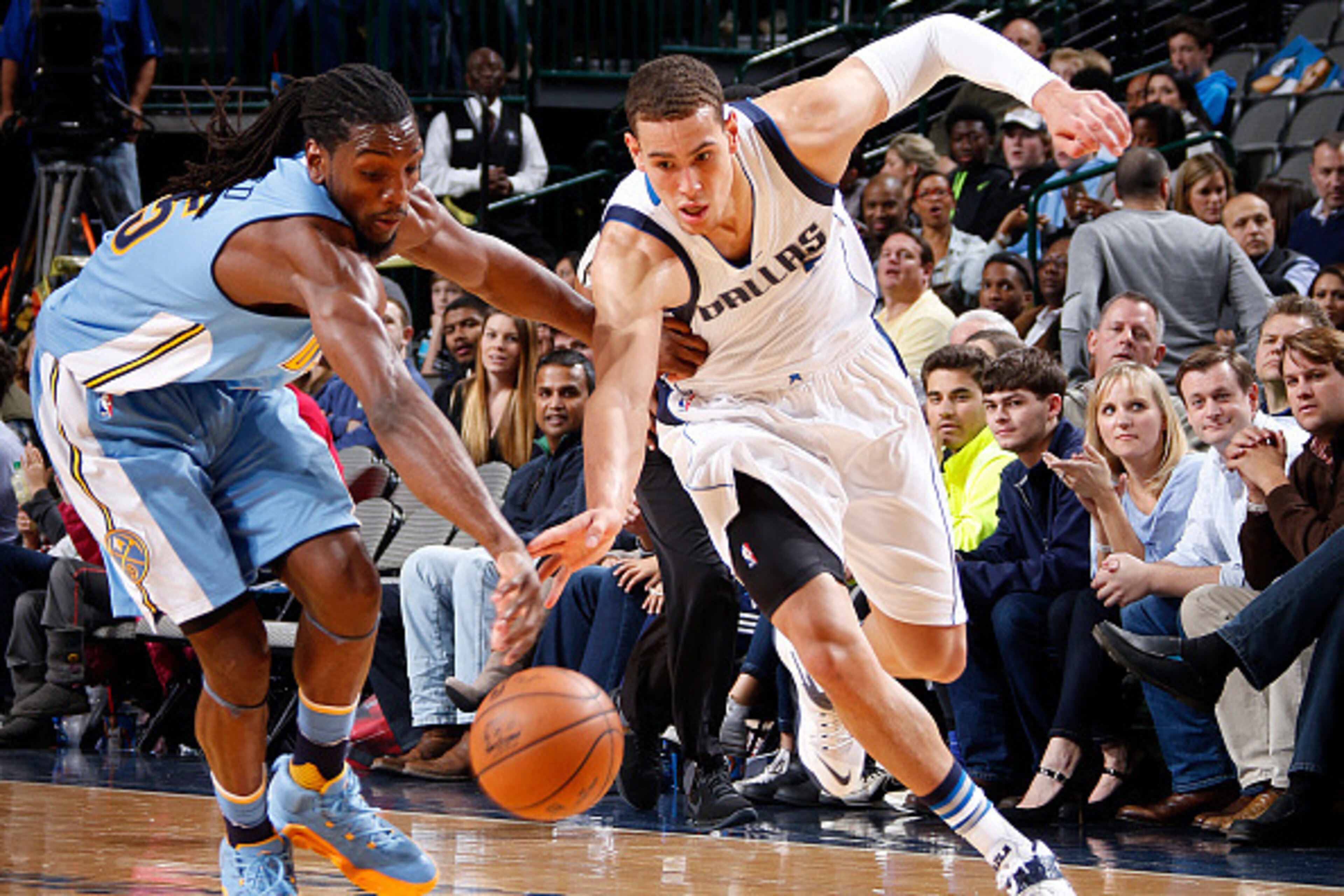 DALLAS, TX - NOVEMBER 28: Dwight Powell #7 of the Dallas Mavericks tries to keep the ball away from Kenneth Faried #35 of the Denver Nuggets on November 28, 2015 at the American Airlines Center in Dallas, Texas. NOTE TO USER: User expressly acknowledges a