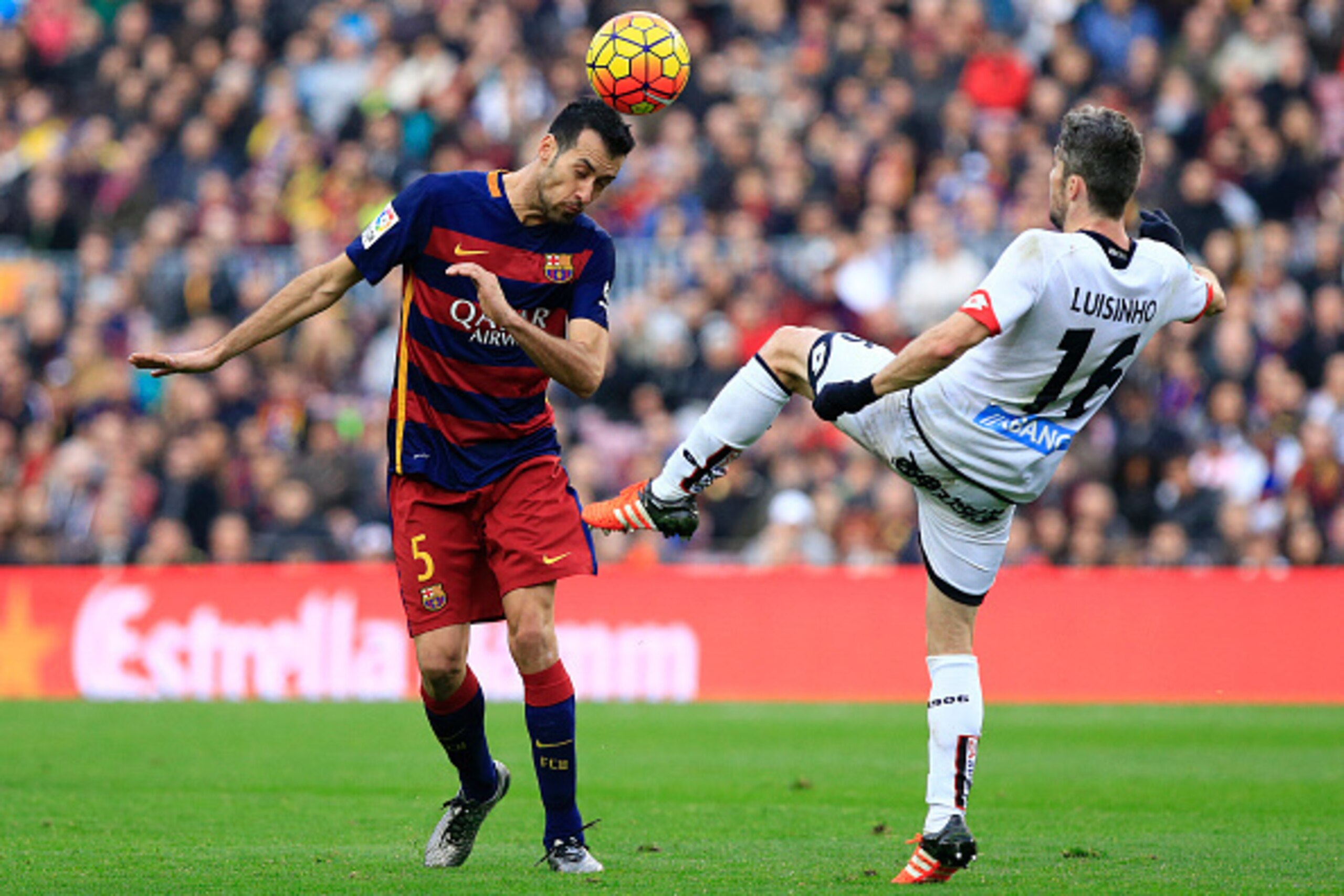 FC Barcelona's Spanish midfielder Sergio Busquets (L) vies with Deportivo de La Coruna's Portuguese midfielder Luisinho during the Spanish league football match FC Barcelona vs Deportivo de La Coruna at the Camp Nou stadium in Barcelona on December 12, 20