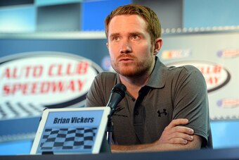 FONTANA, CA - MARCH 22:  Brian Vickers, driver of the Michael Waltrip Racing Toyota, answers questions from media during a press conference before the NASCAR Sprint Cup Series Auto Club 400 at Auto Club Speedway on March 22, 2015 in Fontana, California.  
