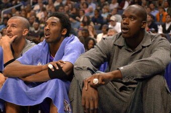 WASHINGTON, :  Phoenix Suns' gurard Jason Kidd (L), Los Angeles Lakers' guard Kobe Bryant (C) and Los Angeles Lakers' center Shaquille O'Neal (R) watch the second half action courtside during the 2001 NBA All-Star Game 11 February 2001 at the MCI Center i
