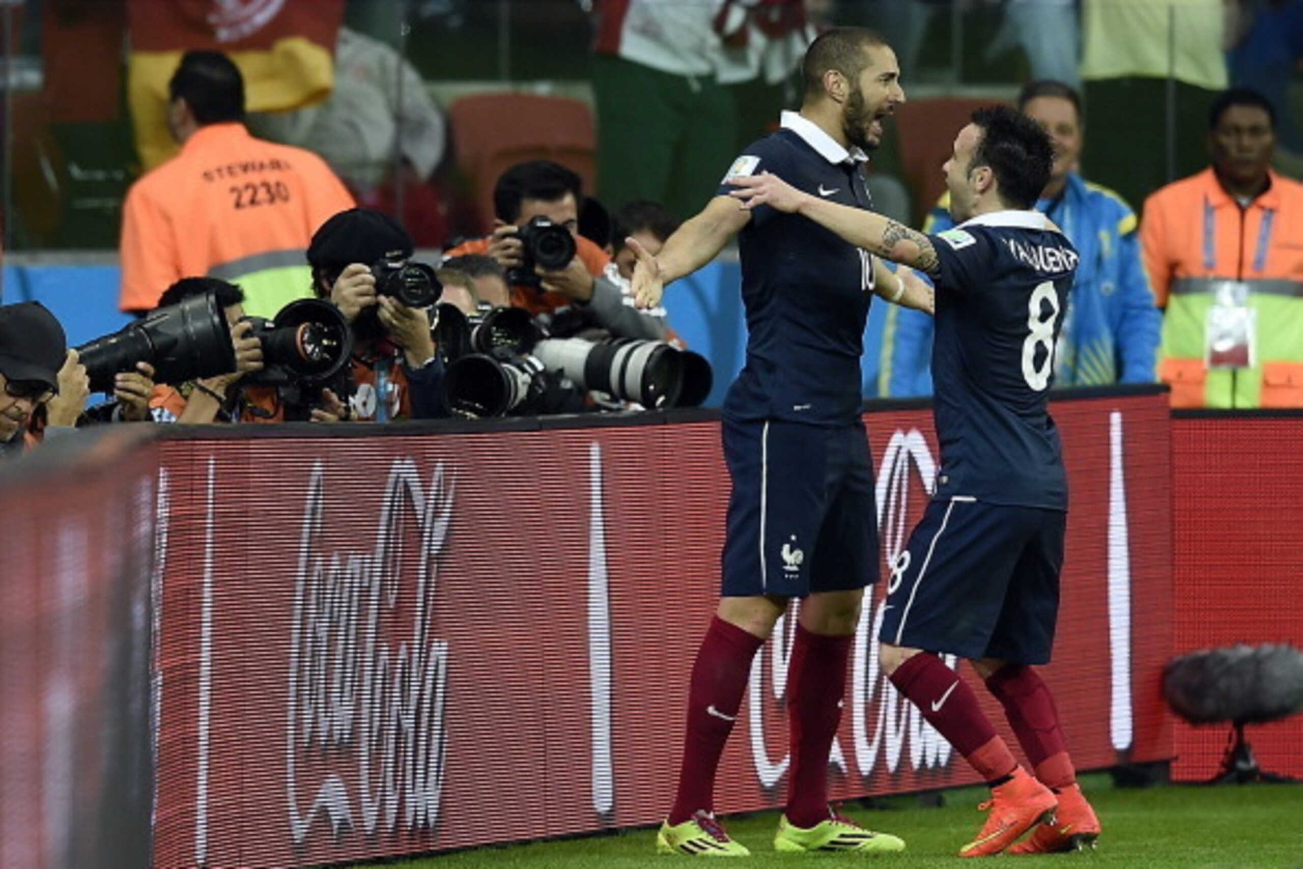 France's forward Karim Benzema (L) celebrates with teammate midfielder Mathieu Valbuena after scoring during the Group E football match between France and Honduras at the Beira-Rio Stadium in Porto Alegre on June 15, 2014, during the 2014 FIFA World Cup. 