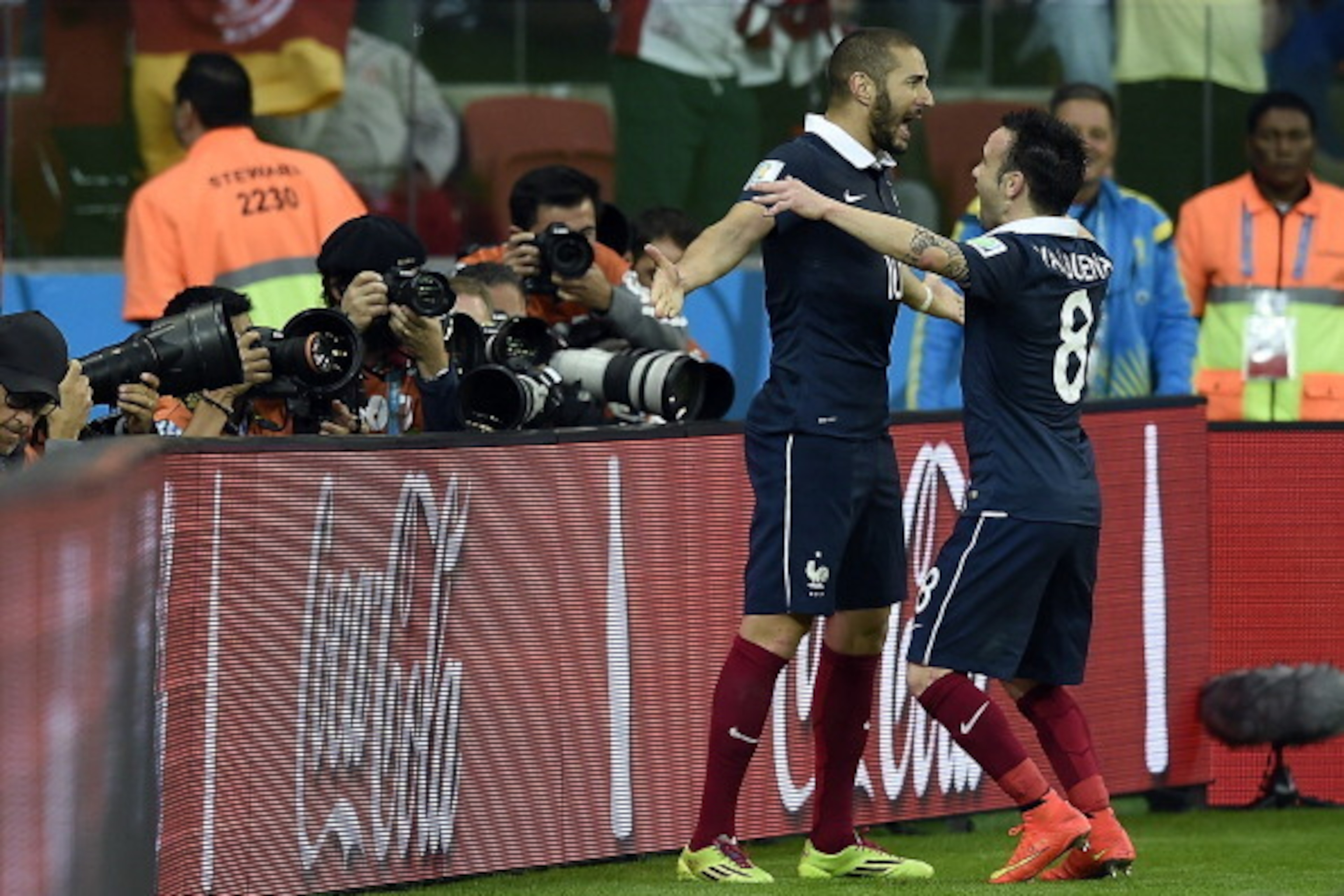 France's forward Karim Benzema (L) celebrates with teammate midfielder Mathieu Valbuena after scoring during the Group E football match between France and Honduras at the Beira-Rio Stadium in Porto Alegre on June 15, 2014, during the 2014 FIFA World Cup. 