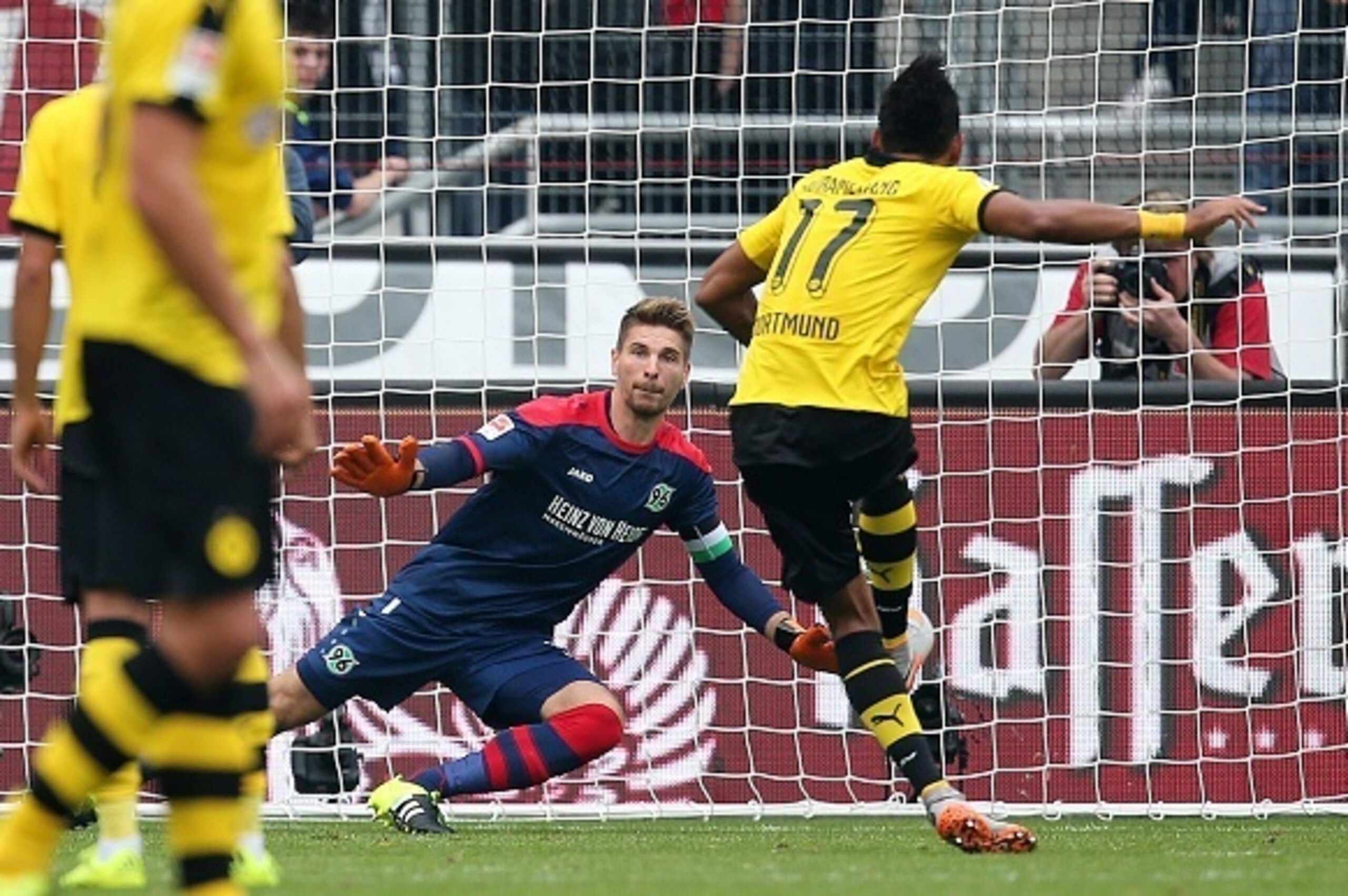 Dortmund's Gabonese striker Pierre-Emerick Aubameyang (R) scores his team's first goal against Hanover's goalkeeper Ron-Robert Zieler (2nd R) during the German first division Bundesliga football match Hannover 96 v Borussia Dortmund, in Hanover, on Septem