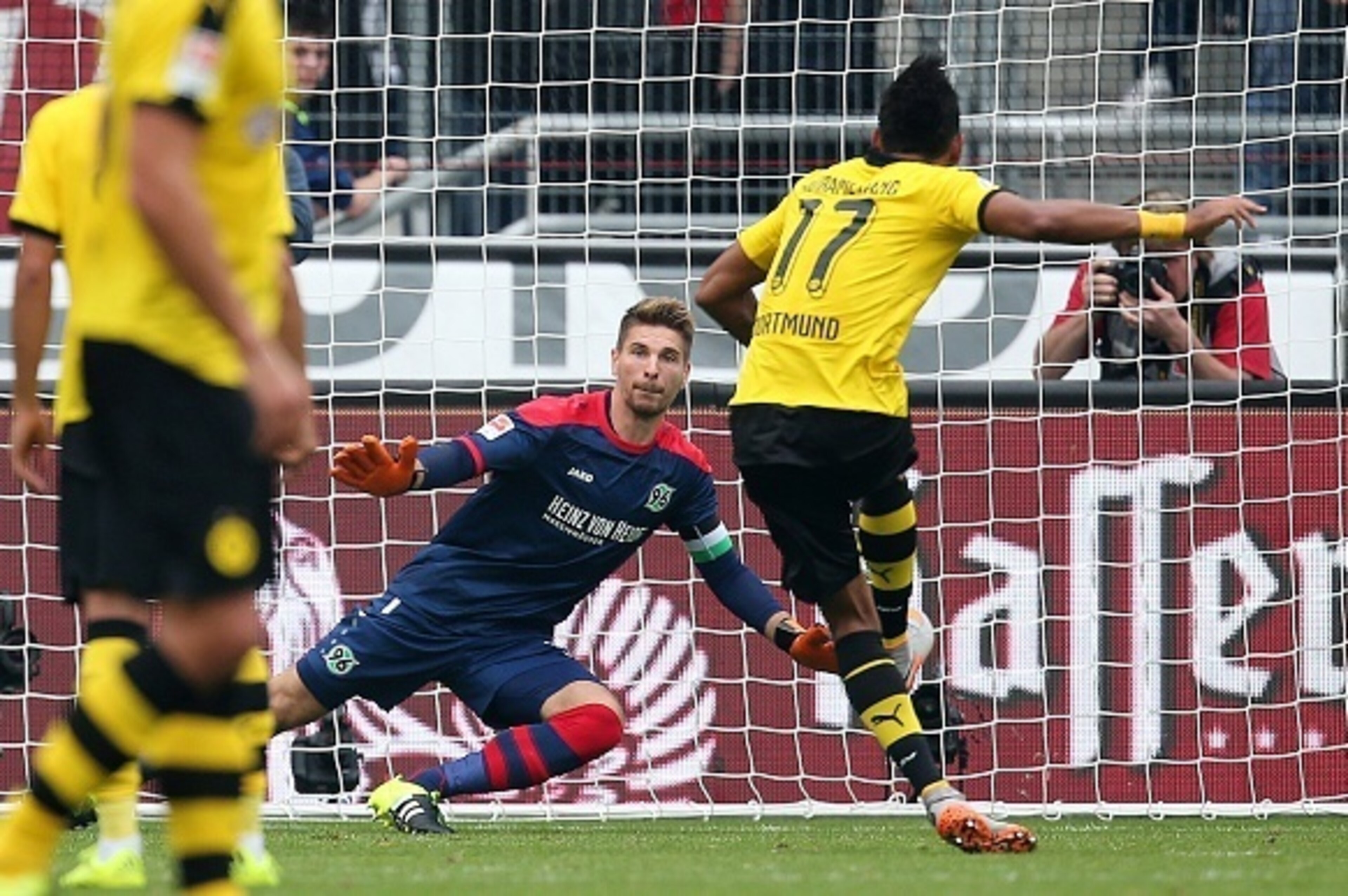 Dortmund's Gabonese striker Pierre-Emerick Aubameyang (R) scores his team's first goal against Hanover's goalkeeper Ron-Robert Zieler (2nd R) during the German first division Bundesliga football match Hannover 96 v Borussia Dortmund, in Hanover, on Septem