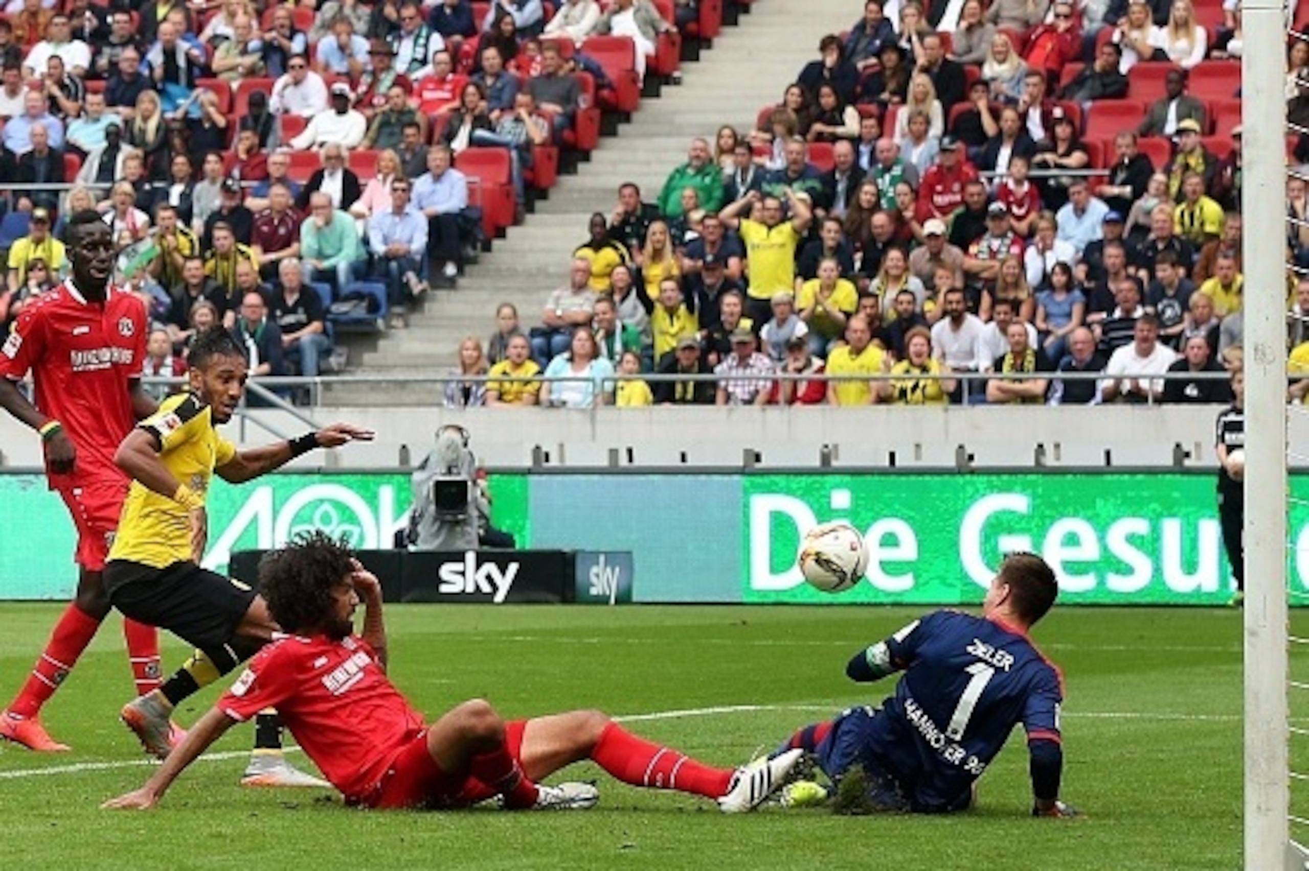 Dortmund's midfielder Gabonese striker Pierre-Emerick Aubameyang (2ndL) scores his team's third goal against Hanover's French defender Salif Sane (L), Hanover's Brazilian defender Felipe (3rdL) and Hanover's goalkeeper Ron-Robert Zieler (R) during the Ger