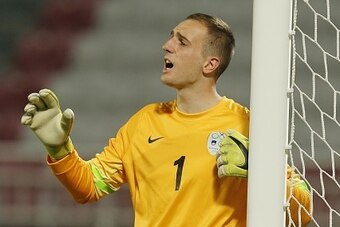 Slovenia's Jan Oblak shouts to his team during their friendly football match against Qatar on March 30, 2015 at the Lekwiya SC Stadium in Doha. AFP PHOTO / AL-WATAN DOHA / KARIM JAAFAR 
== QATAR OUT ==        (Photo credit should read KARIM JAAFAR/AFP/Get