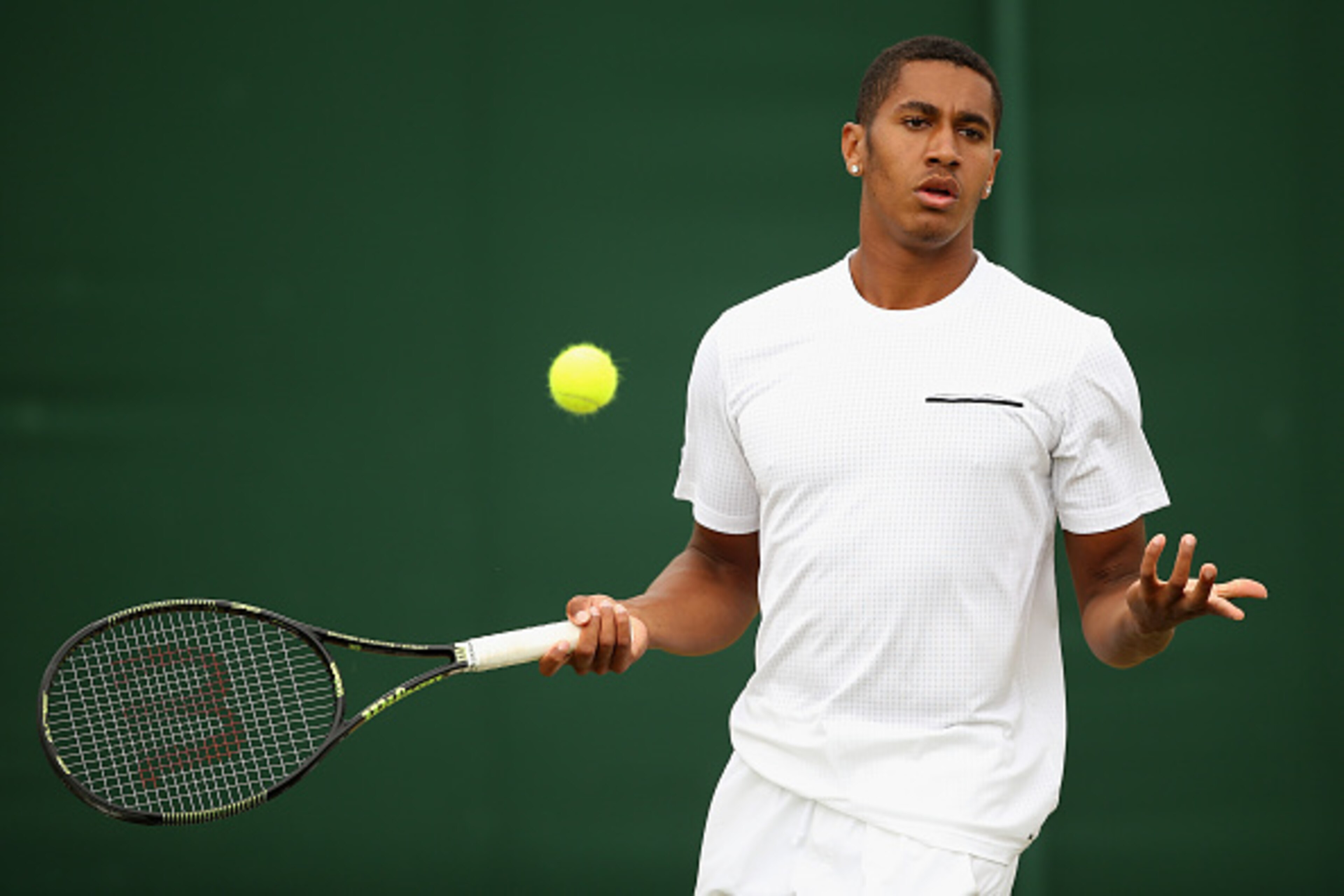LONDON, ENGLAND - JULY 06: Michael Mmoh of the United States reacts in his Boy's Singles First Round match against Geoffrey Blancaneaux of France during day seven of the Wimbledon Lawn Tennis Championships at the All England Lawn Tennis and Croquet Club LONDON, ENGLAND - JULY 06: Michael Mmoh of the United States reacts in his Boy's Singles First Round match against Geoffrey Blancaneaux of France during day seven of the Wimbledon Lawn Tennis Championships at the All England Lawn Tennis and Croquet Club