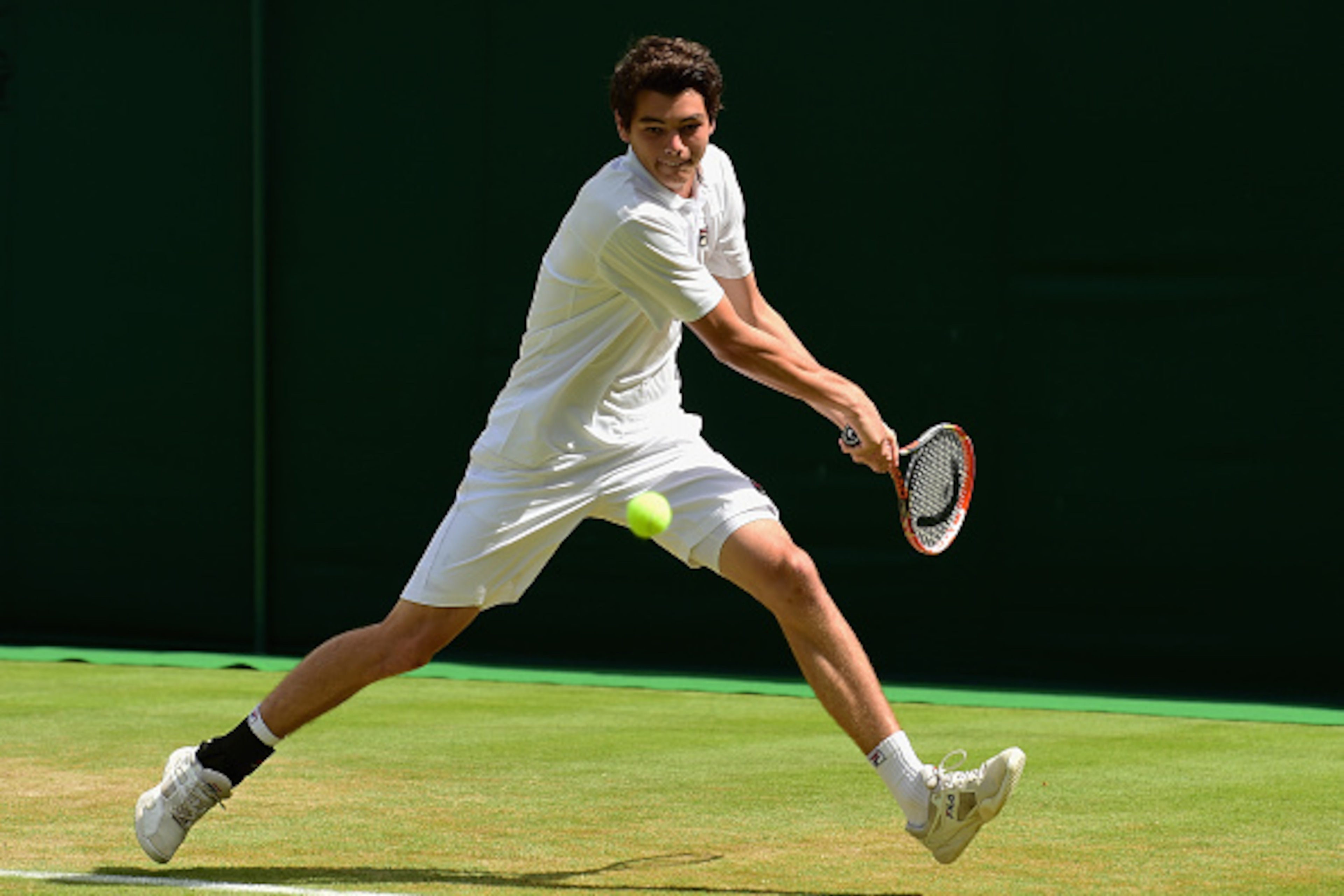 LONDON, ENGLAND - JULY 07: Taylor Fritz of the United States in action during the Boys Singles Second Round match against Sora Fukuda of Japan on day eight of the Wimbledon Lawn Tennis Championships at the All England Lawn Tennis and Croquet Club on Ju LONDON, ENGLAND - JULY 07: Taylor Fritz of the United States in action during the Boys Singles Second Round match against Sora Fukuda of Japan on day eight of the Wimbledon Lawn Tennis Championships at the All England Lawn Tennis and Croquet Club on Ju