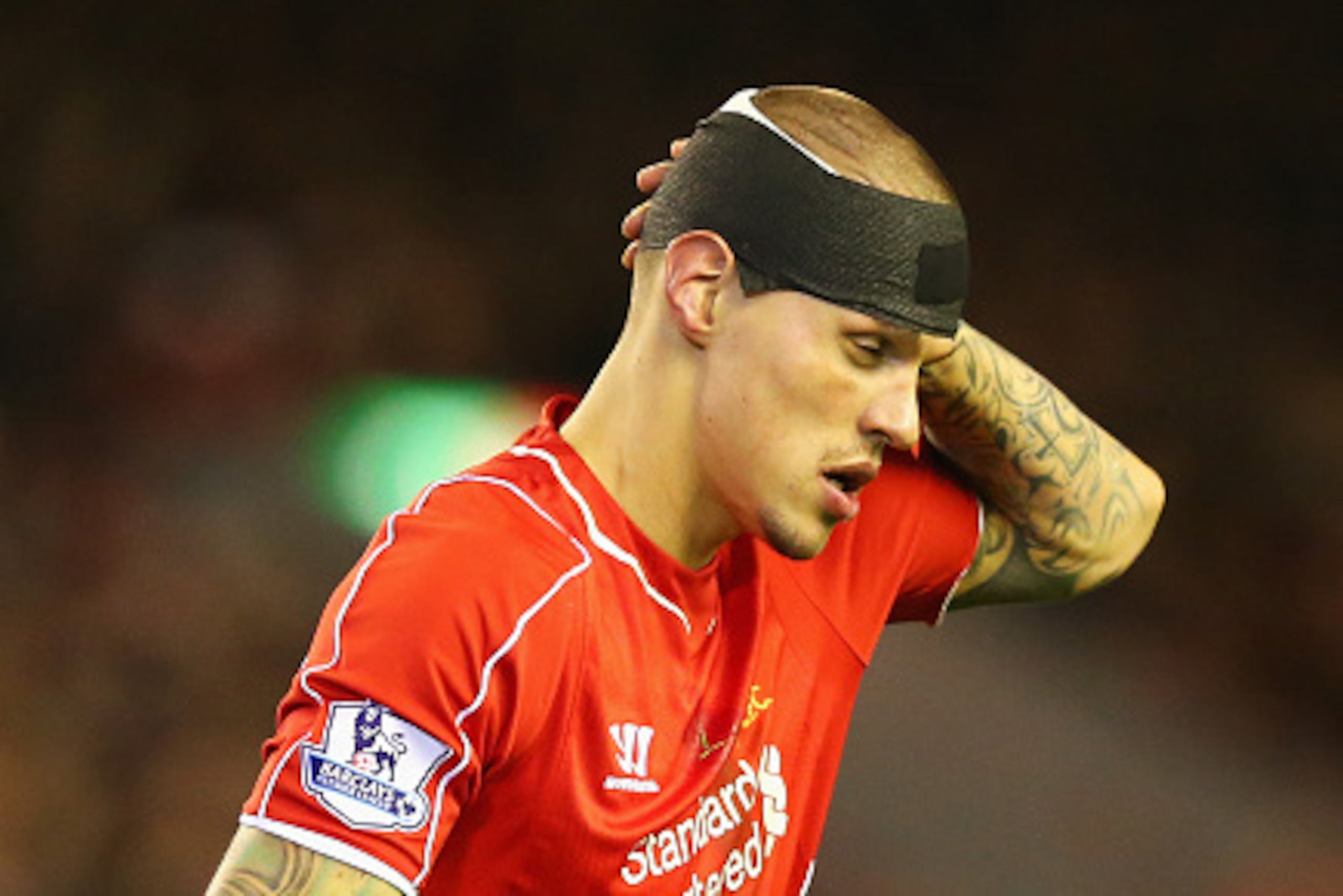 LIVERPOOL, ENGLAND - DECEMBER 21:  Martin Skrtel of Liverpool looks on with his head bandaged during the Barclays Premier League match between Liverpool and Arsenal at Anfield on December 21, 2014 in Liverpool, England.  (Photo by Alex Livesey/Getty Image