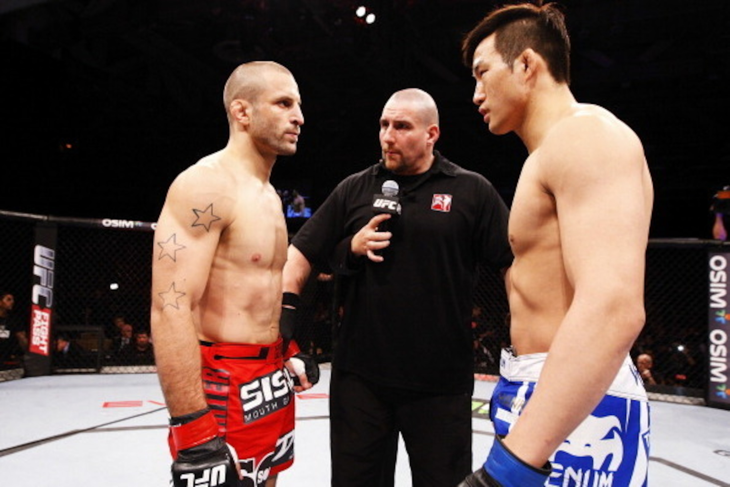 SINGAPORE - JANUARY 04:  (L to R) Tarec Saffiedine  and Lim Hyun Gyu face off in their welterweight bout during the UFC Fight Night event at the Marina Bay Sands Resort on January 4, 2014 in Singapore. (Photo by Mitch Viquez/Zuffa LLC/Zuffa LLC via Getty 