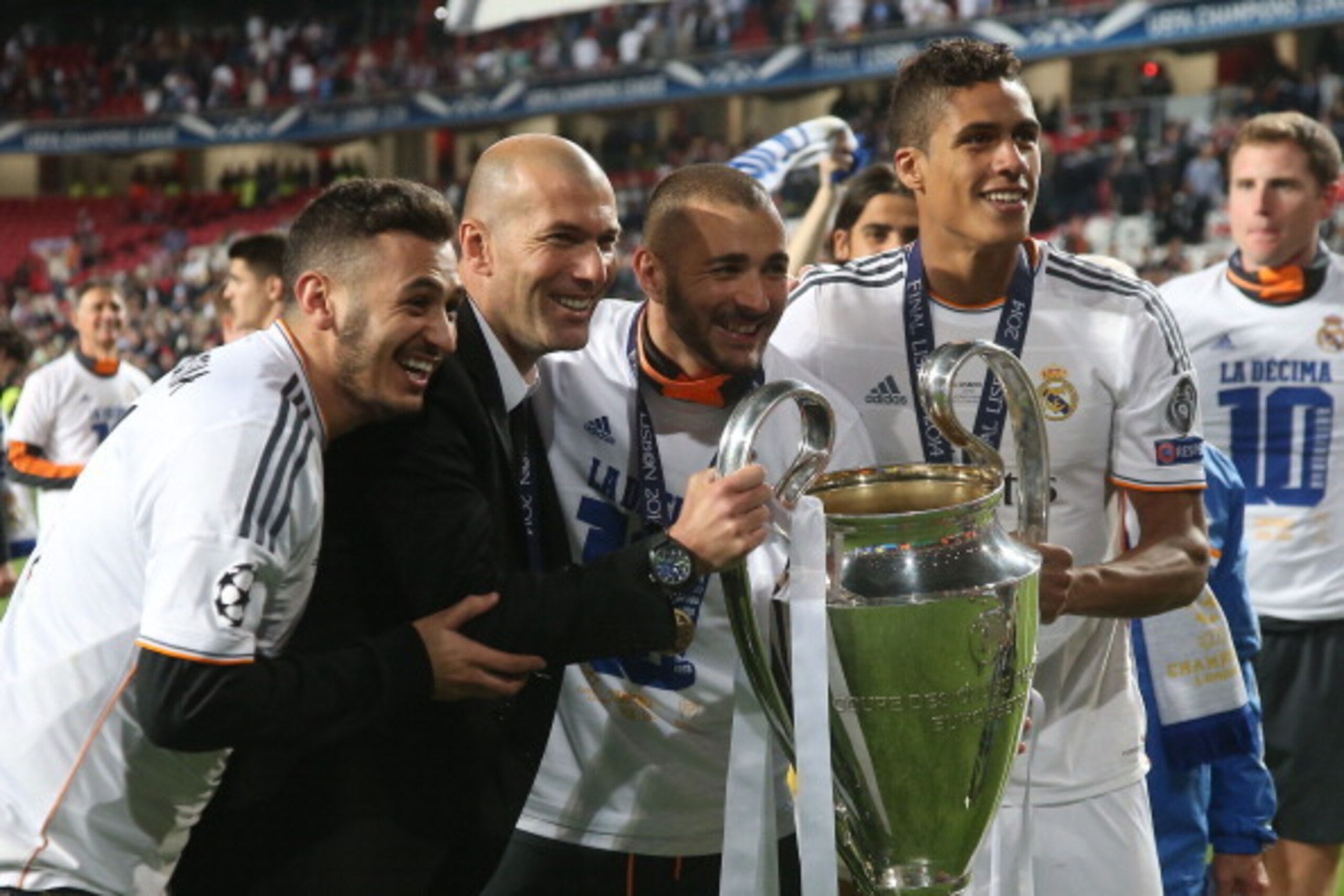 LISBON, PORTUGAL - MAY 24: Assistant-coach of Real Madrid Zinedine Zidane, Karim Benzema and Raphael Varane of Real Madrid hold the trophy after the UEFA Champions League final between Real Madrid and Atletico de Madrid at Estadio da Luz stadium on May 24 LISBON, PORTUGAL - MAY 24: Assistant-coach of Real Madrid Zinedine Zidane, Karim Benzema and Raphael Varane of Real Madrid hold the trophy after the UEFA Champions League final between Real Madrid and Atletico de Madrid at Estadio da Luz stadium on May 24