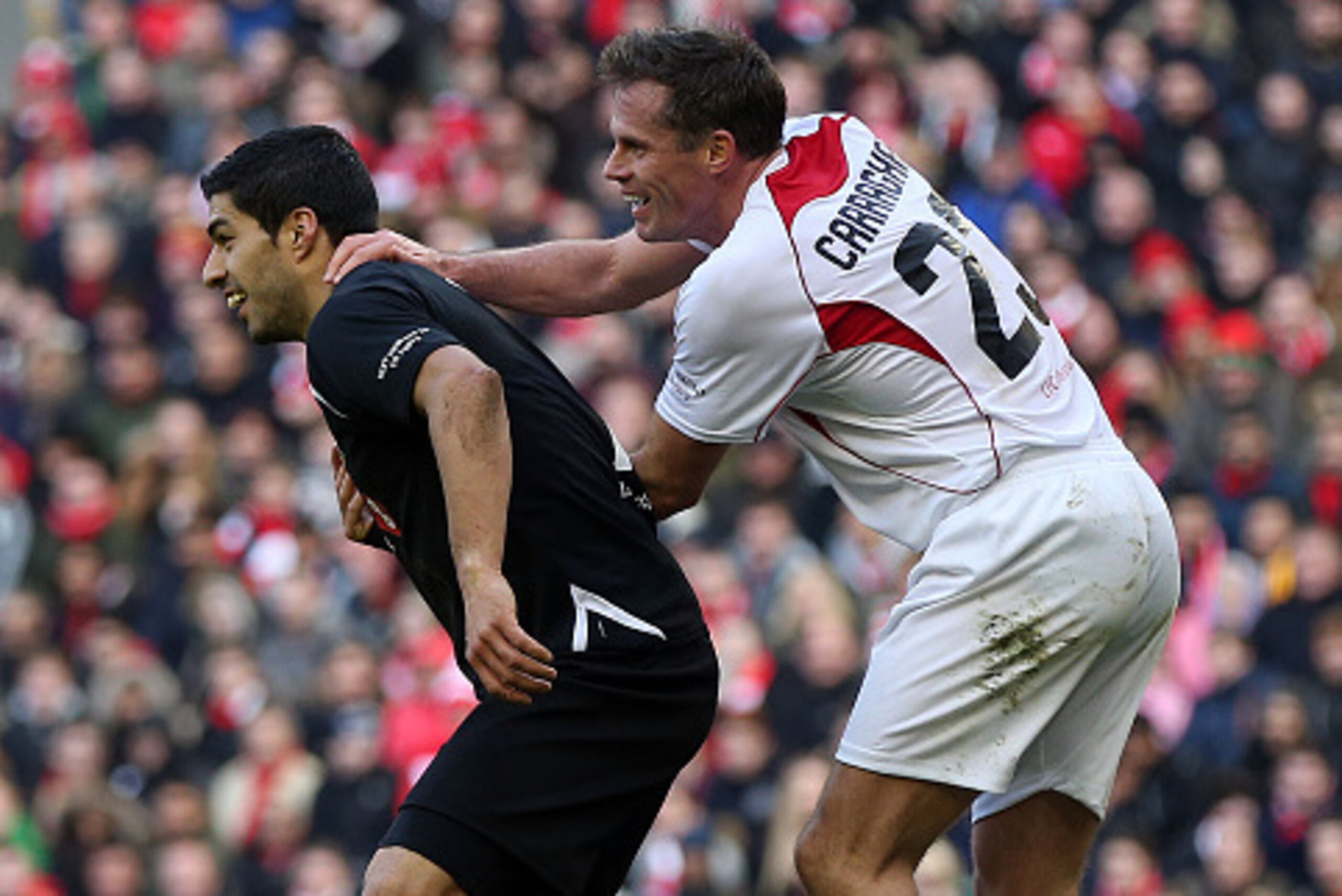 LIVERPOOL, ENGLAND - MARCH 29: Luis Suarez of the Gerrard XI tussles with Jamie Carragher of the Carragher XI during the Liverpool All-Star Charity match at Anfield on March 29, 2015 in Liverpool, England. (Photo by Chris Brunskill/Getty Images)