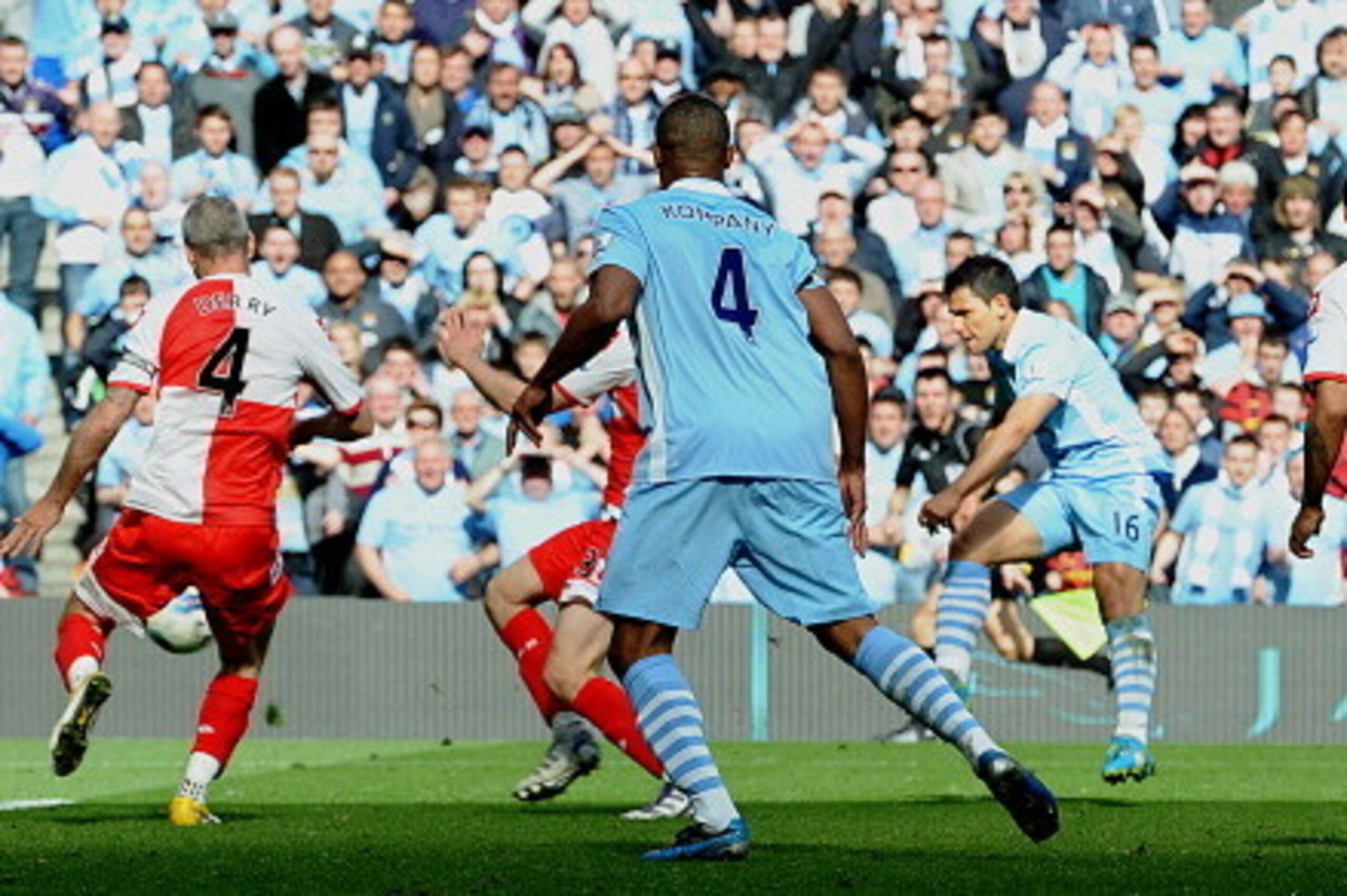 Manchester City's Argentinian striker Sergio Aguero (3rd R) scores their late winning goal during the English Premier League football match between Manchester City and Queens Park Rangers at The Etihad stadium in Manchester, north-west England on May 13, 