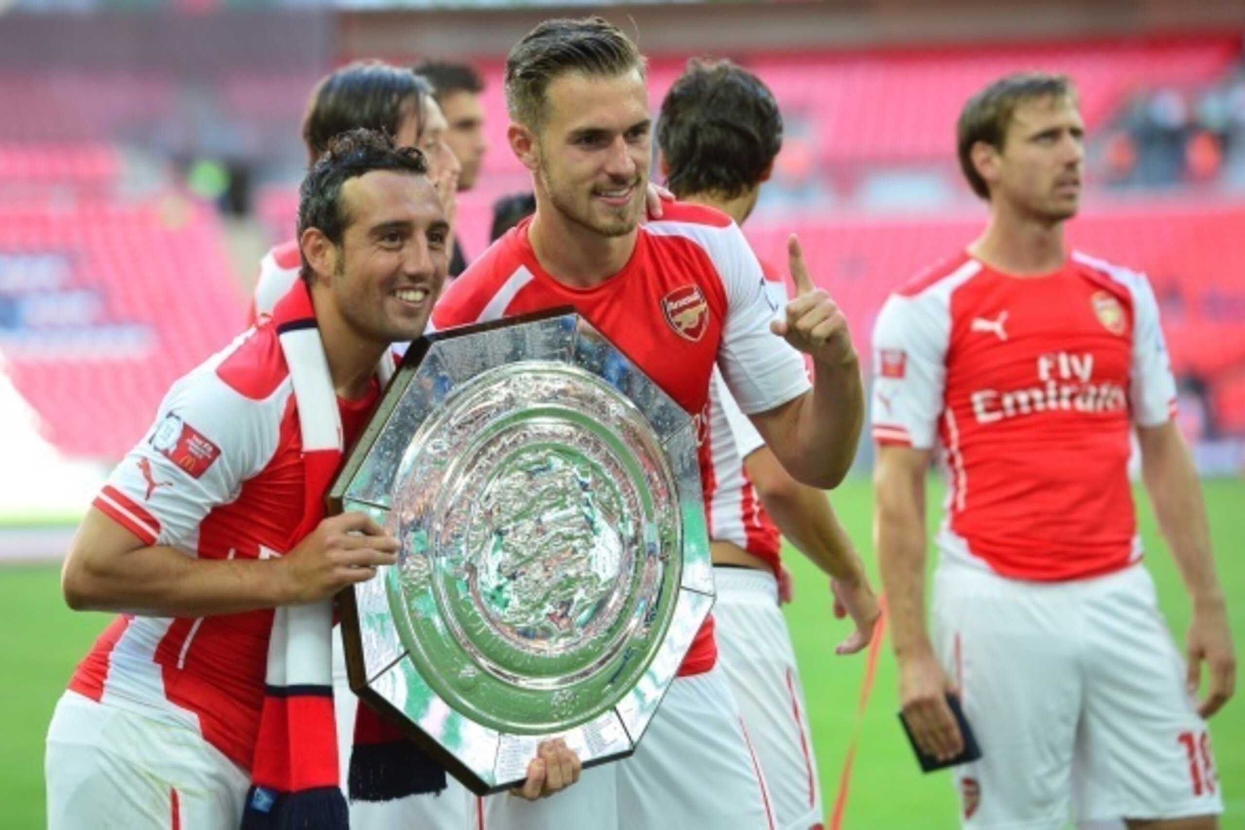 (L-R) Arsenal's Spanish midfielder Santi Cazorla and Arsenal's Welsh midfielder Aaron Ramsey pose with the Community Shield trophy after Arsenal won the FA Community Shield football match between Arsenal and Manchester City at Wembley Stadium in north Lon (L-R) Arsenal's Spanish midfielder Santi Cazorla and Arsenal's Welsh midfielder Aaron Ramsey pose with the Community Shield trophy after Arsenal won the FA Community Shield football match between Arsenal and Manchester City at Wembley Stadium in north Lon