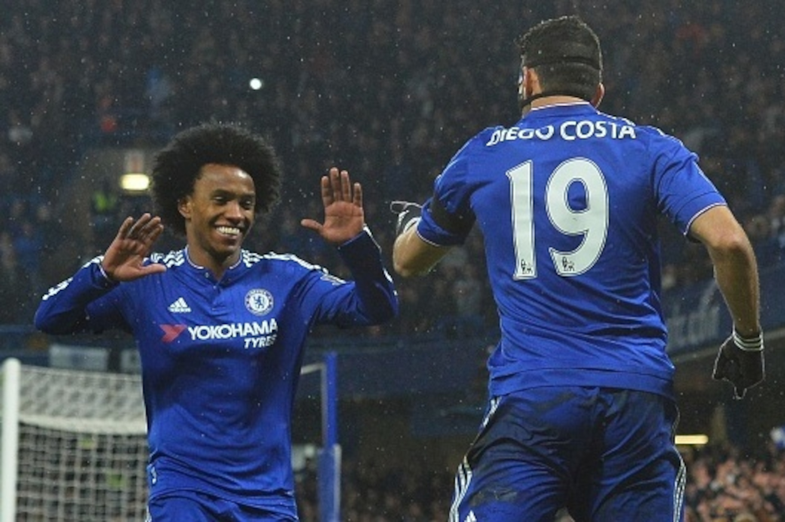 Chelsea's Brazilian-born Spanish striker Diego Costa (R) celebrates scoring his team's first goal with Chelsea's Brazilian midfielder Willian during the English Premier League football match between Chelsea and Newcastle United at Stamford Bridge in Londo