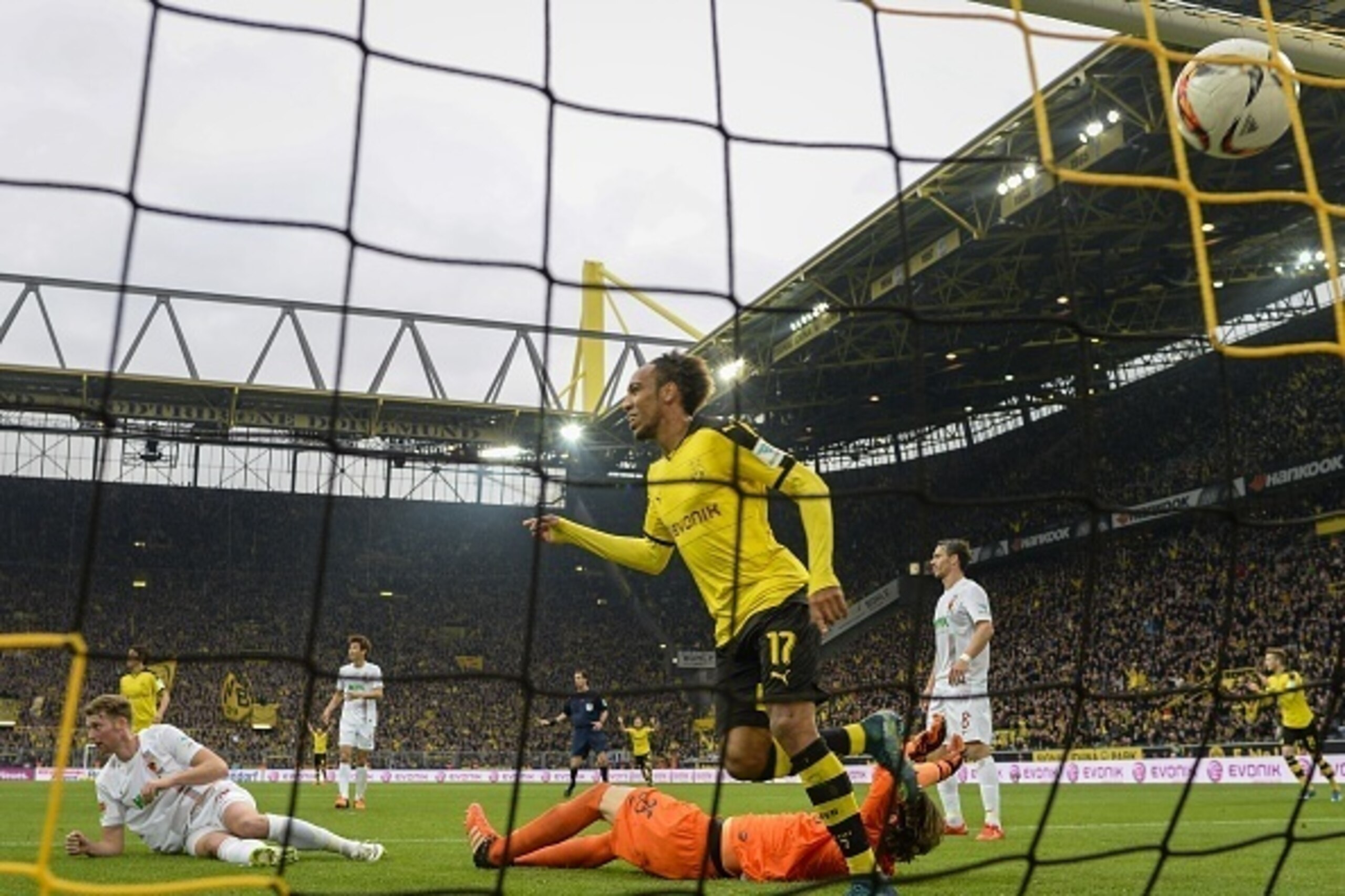 Dortmund's Gabonese midfielder Pierre-Emerick Aubameyang celebrates scoring the opening goal past Augsburg's Swiss goalkeeper Marwin Hitz during the German first division football Bundesliga match between Borussia Dortmund and FC Augsburg on October 25, 2