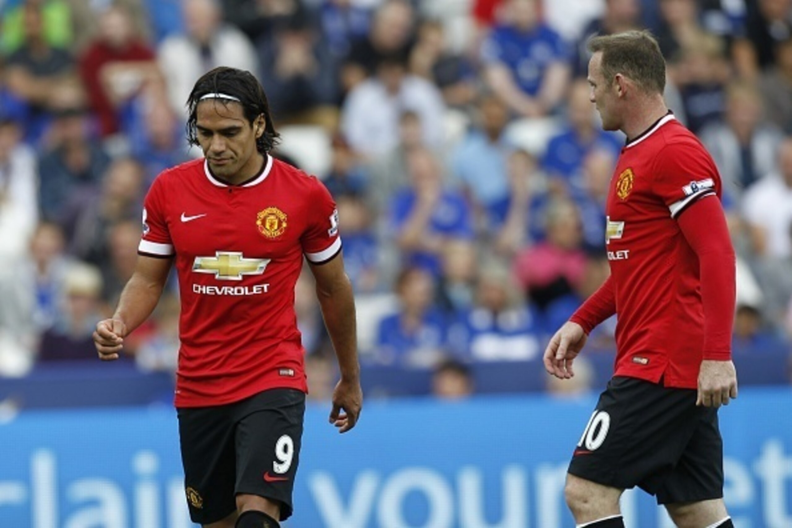 Manchester United's English striker Wayne Rooney (R) and Manchester United's Colombian striker Radamel Falcao (L) react during the English Premier League football match between Leicester City and Manchester United at the King Power Stadium in Leicester on